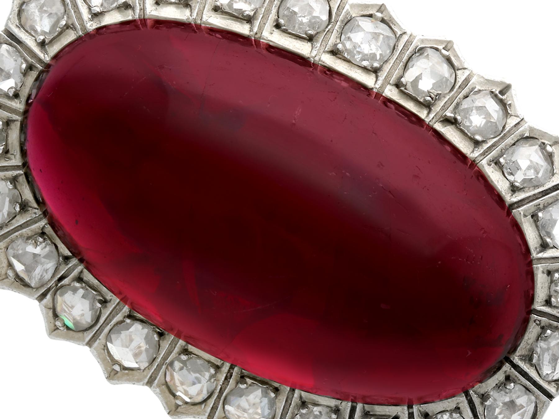 A stunning, fine, and impressive antique 33.88 carat garnet and 1.92 carat diamond 14 karat yellow gold brooch; part of our diverse antique jewelry collections.

This stunning, fine and impressive antique cabochon cut brooch has been crafted in 18k