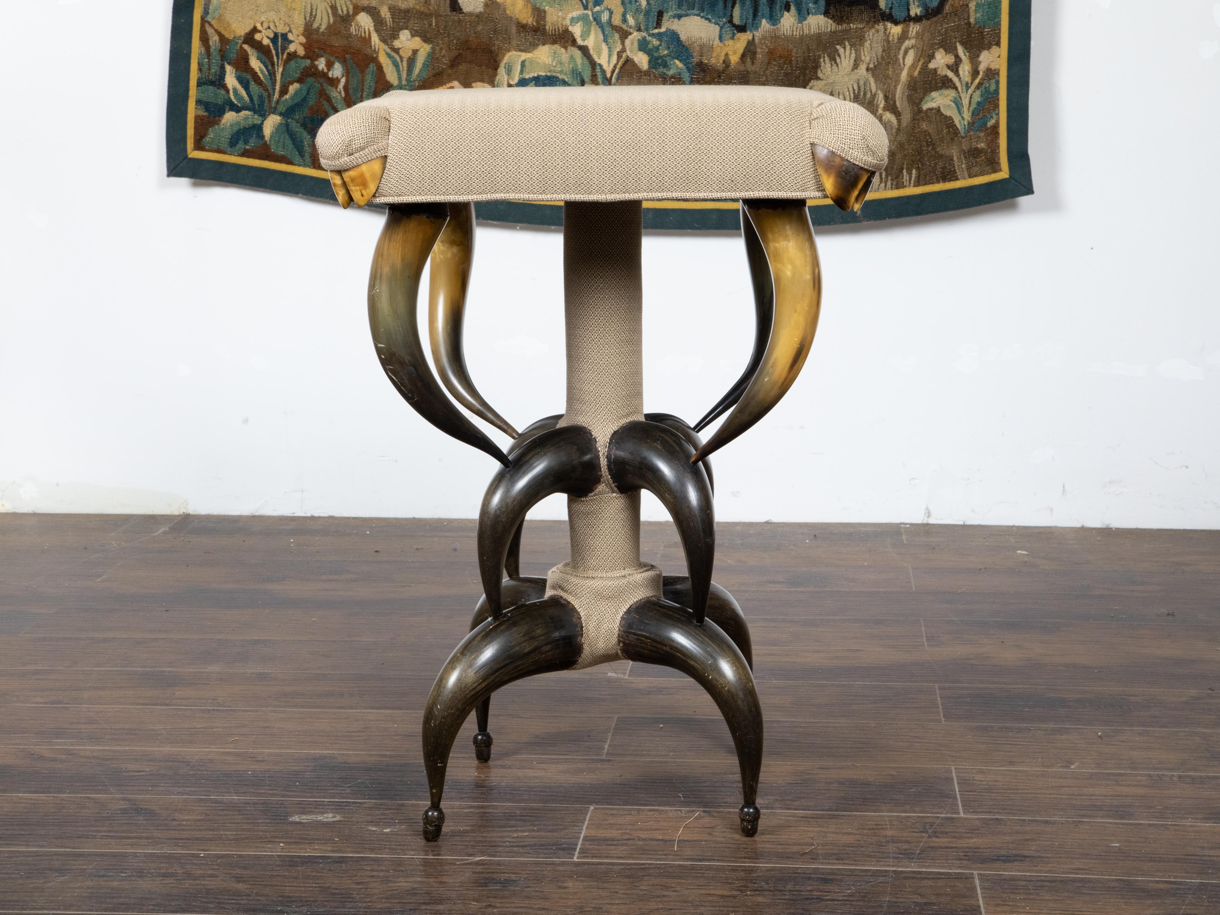 An American horn stool from circa 1880 with custom upholstery. This circa 1880 American horn stool stands as a remarkable testament to the eclectic design trends of the period, showcasing a unique three-tiered construction of meticulously arranged