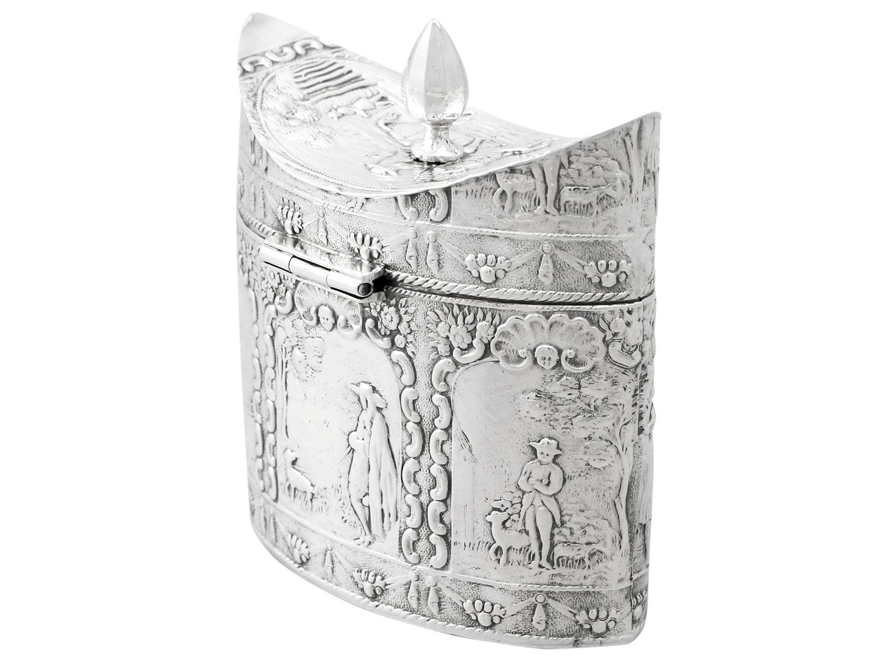 A fine antique Dutch silver tea caddy; an addition to our silver teaware collection.

This fine Dutch silver tea caddy has a navette shaped oval form.

The surface of this antique silver tea caddy is embellished with embossed panels depicting