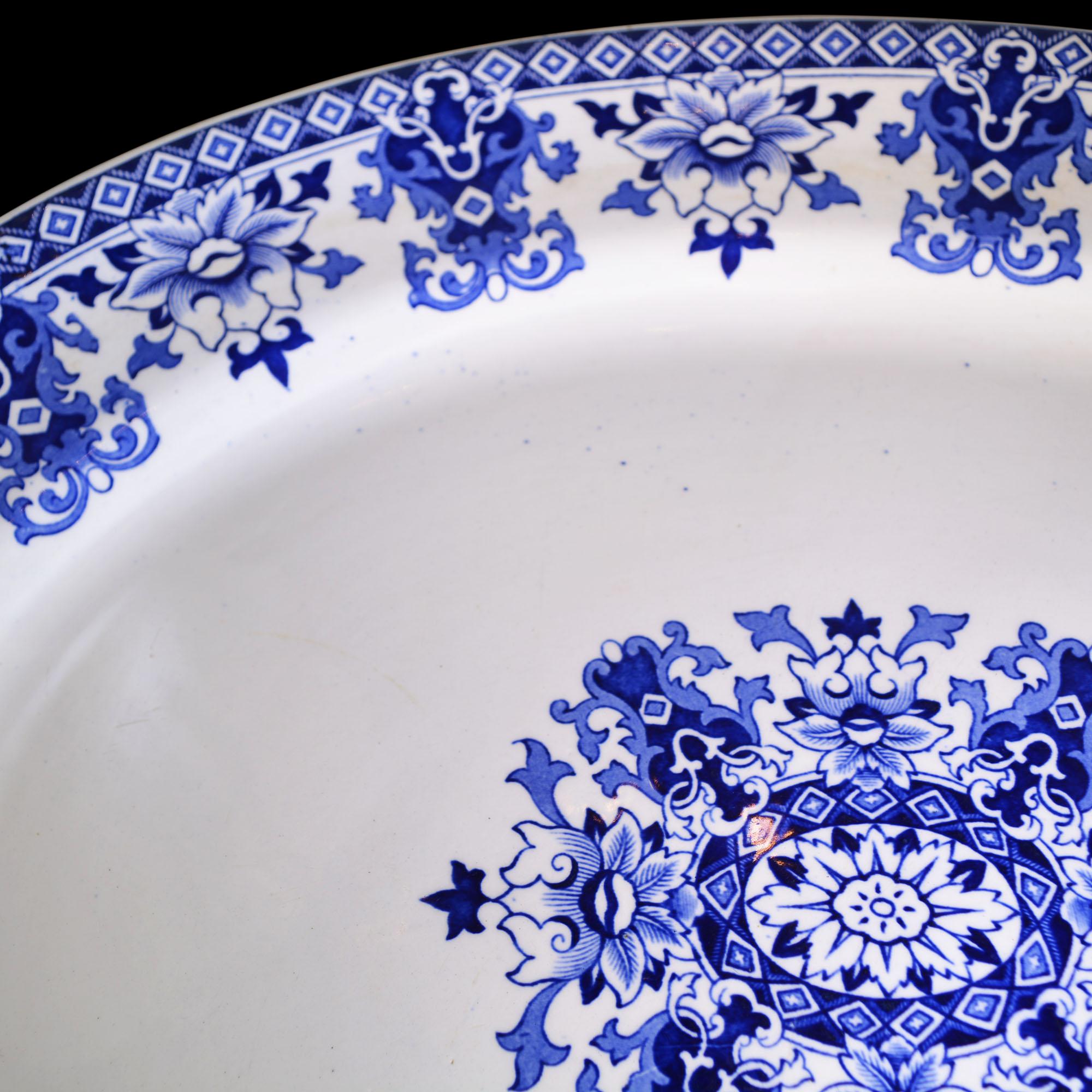 This large platter has the Classic blue and white Lolanthe design. The manufacturer E.F.B & Son is stamped on the back along with the imprint. The platter has an intricate floral center design with coordinating border design. The manufacturer,