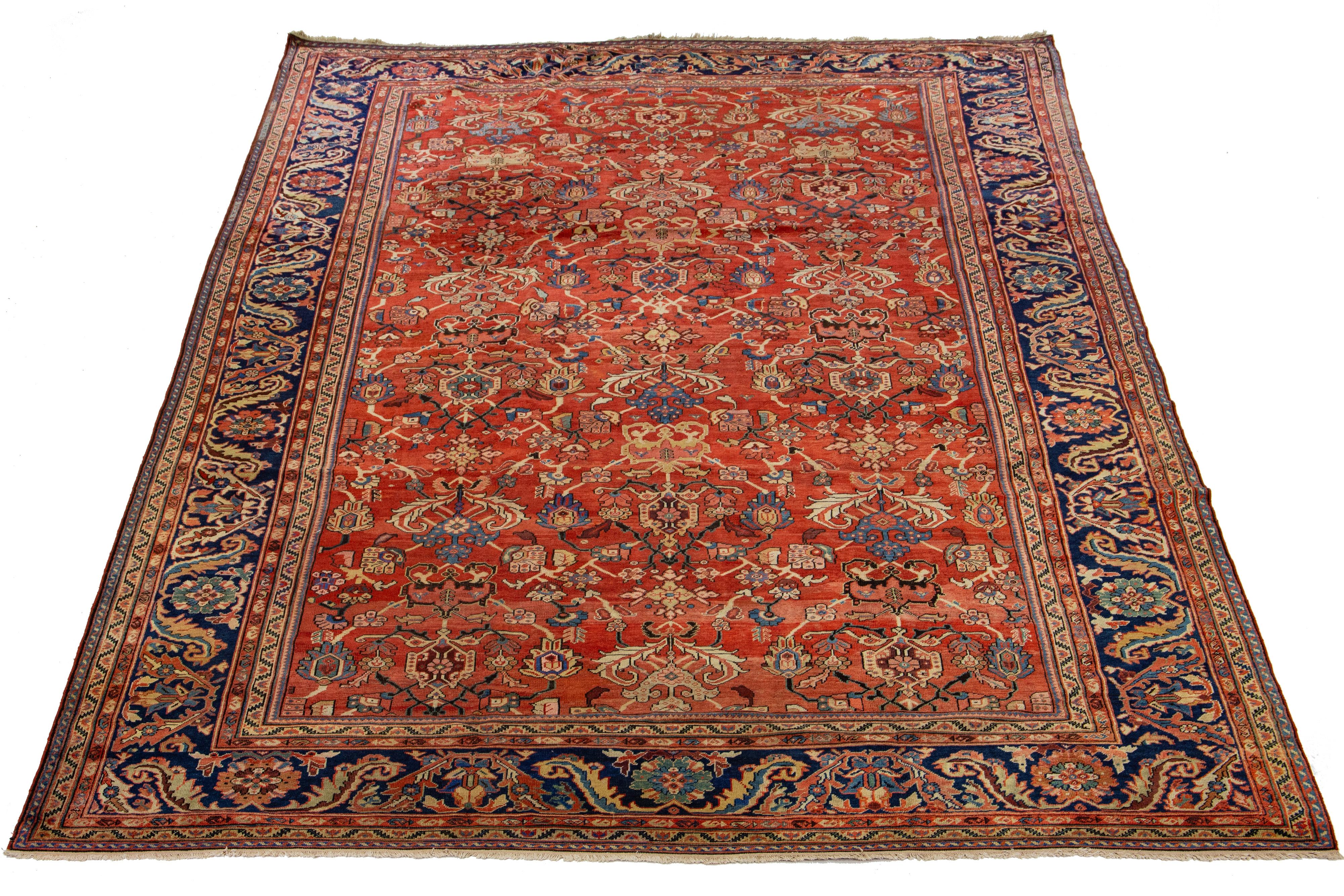 This 1890s antique Sultanabad wool rug is a beautiful hand-knotted piece featuring a red field. It showcases multicolor accents in an all-over floral design, characteristic of Persian rugs. The enduring quality of this classic rug design is
