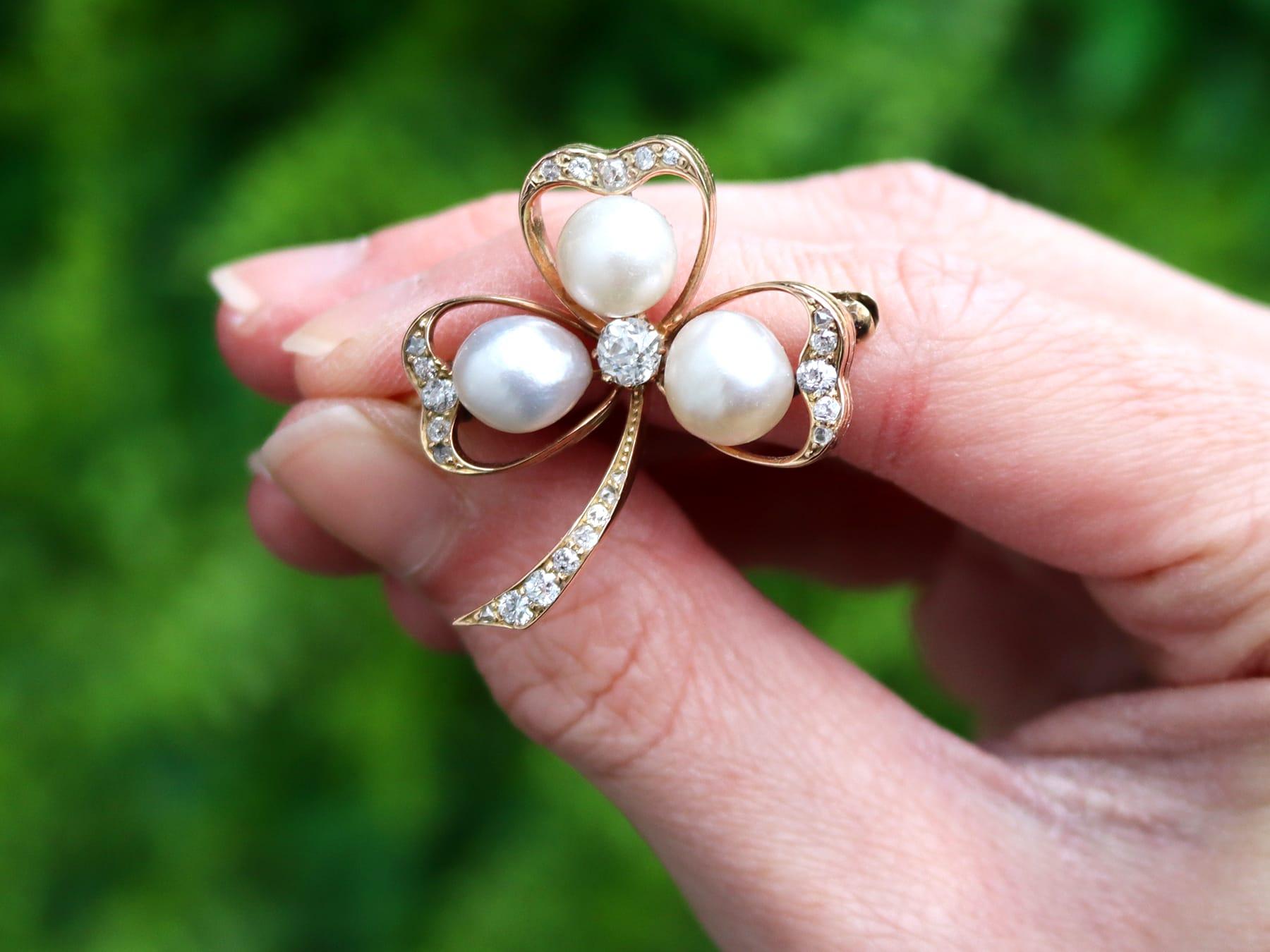 A stunning antique Victorian pearl and 1.05 carat diamond, 14 karat yellow gold brooch in the form of a 'clover'; part of our diverse antique jewelry and estate jewelry collections.

This stunning, fine and impressive antique brooch has been crafted