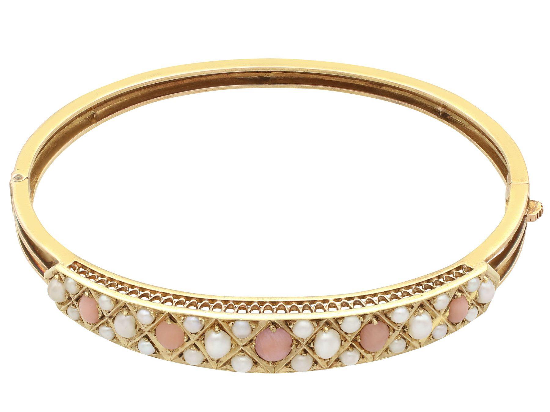 An impressive antique Victorian coral and seed pearl, 15 karat yellow gold bangle; part of our diverse antique jewelry and estate jewelry collections.

This fine and impressive coral and pearl bangle has been crafted in 15k yellow gold.

The