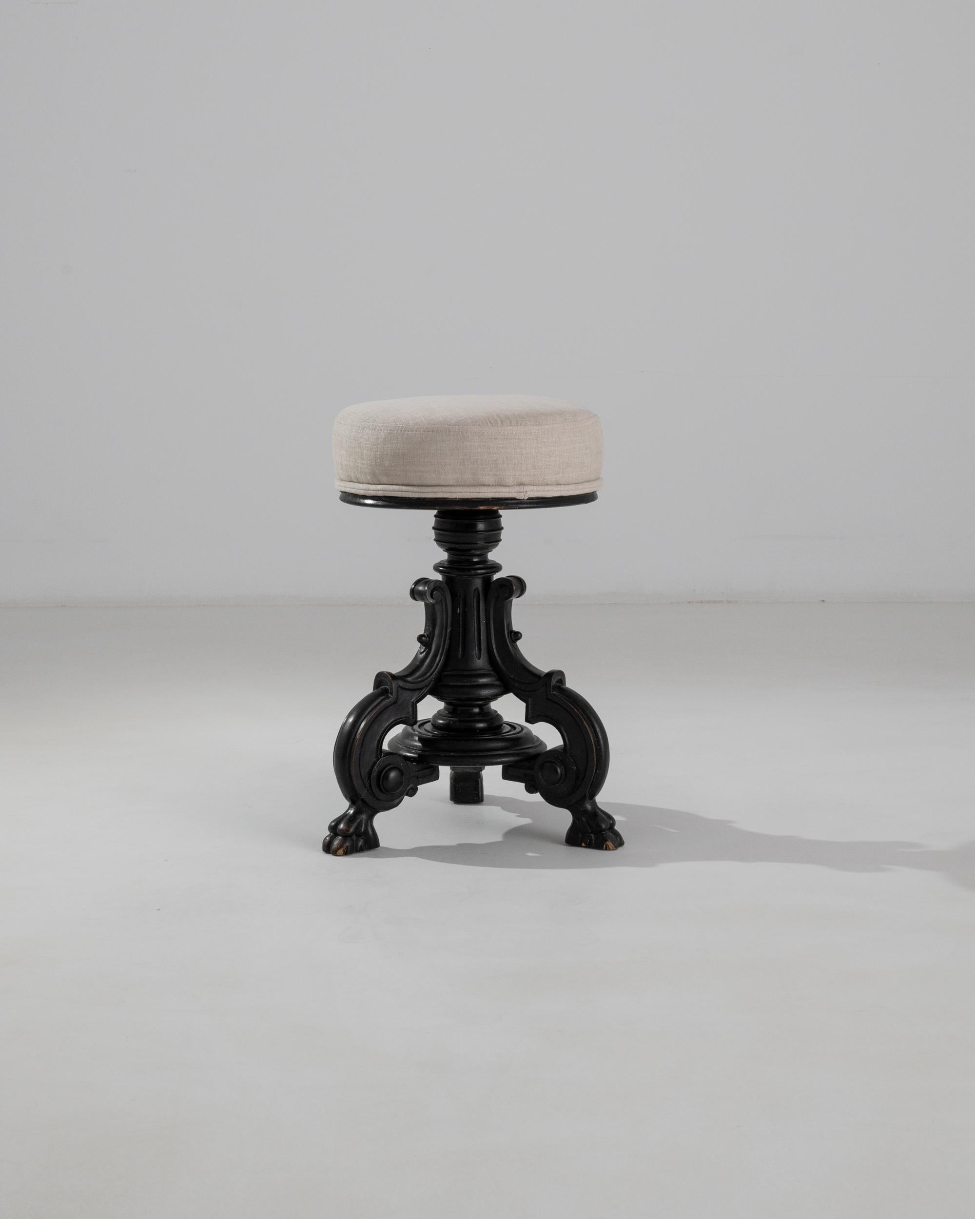 This beautiful antique wooden stool reflects the extravagant decoration of the Belle Epoque. Crafted in 1880s France, the adjustable seat speaks to the mechanical advancements of the era, while the decorative motifs hark back to the glory of
