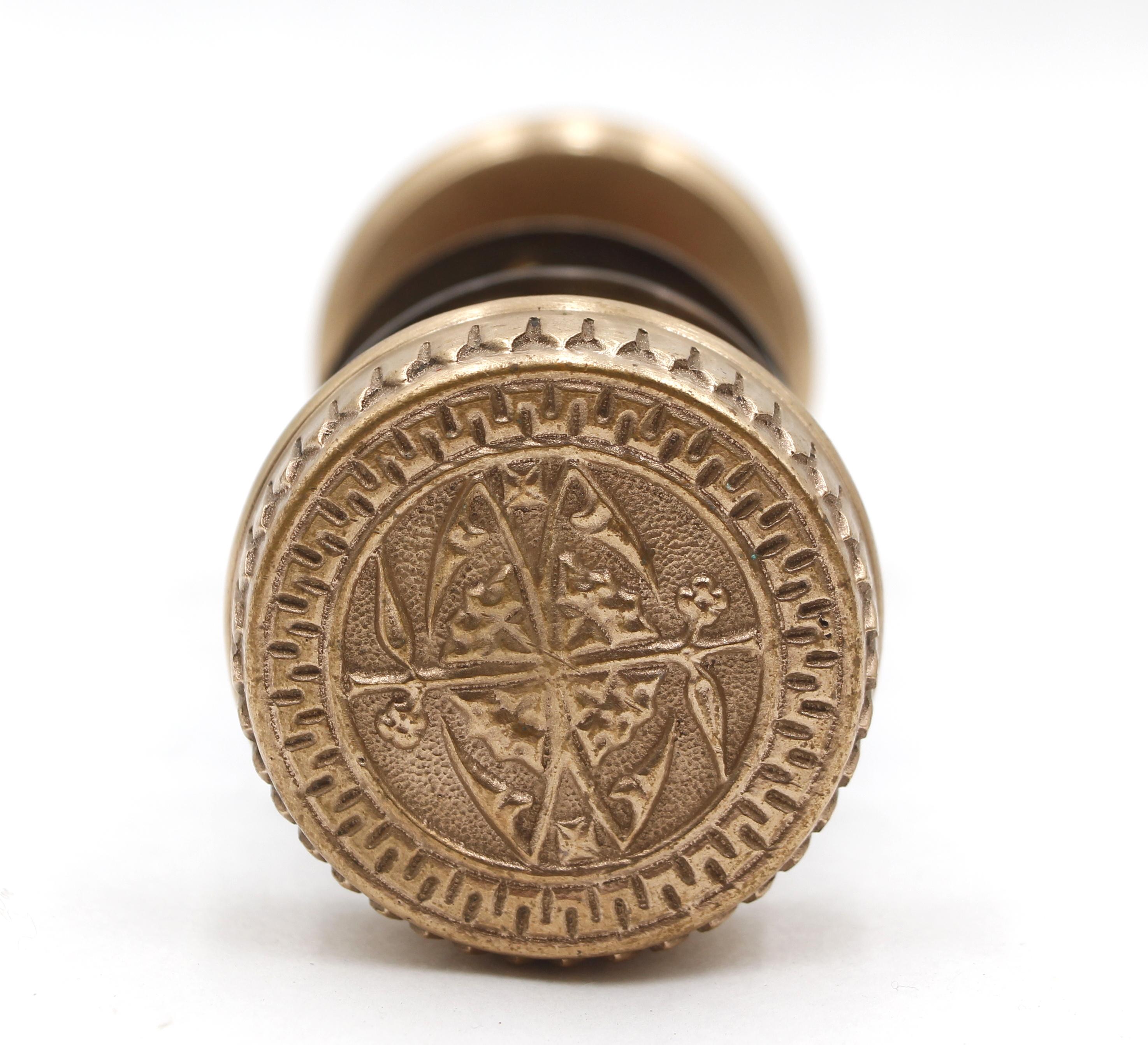 These two-fold Vernacular doorknobs were made by Branford in the 1881 catalog. It is part of the F-20100 group. The ornate brass rosettes are newly made. The rosette mounting screws are included. Priced as two doorknobs, two rosettes, and a spindle.