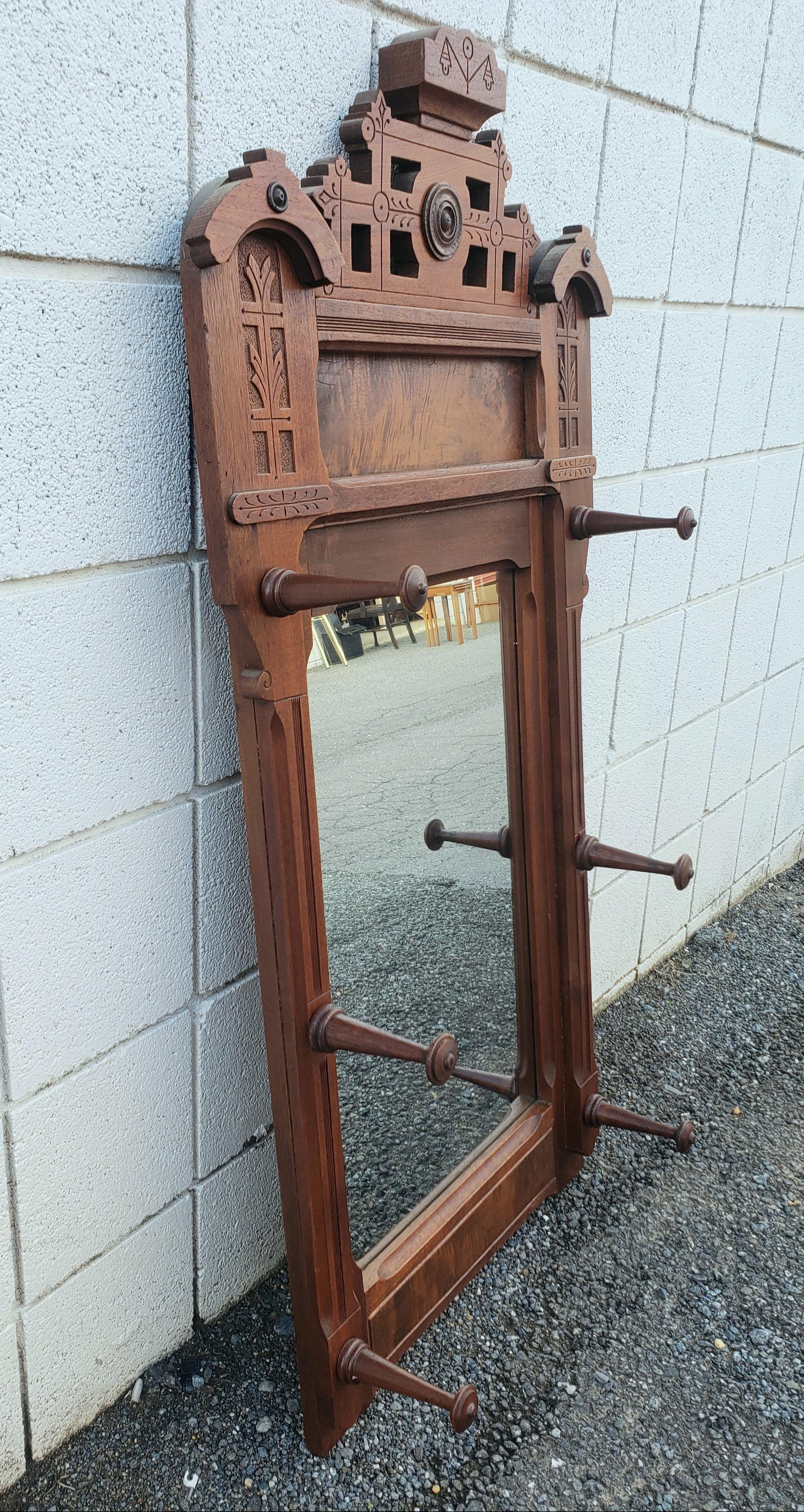 American  1880s Eastlake Walnut Wall Mirror with Hats Pegs For Sale