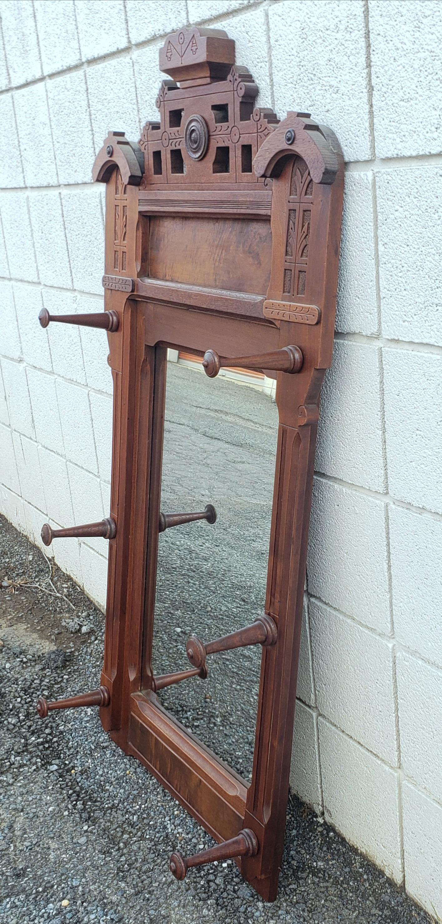 Hand-Carved  1880s Eastlake Walnut Wall Mirror with Hats Pegs For Sale