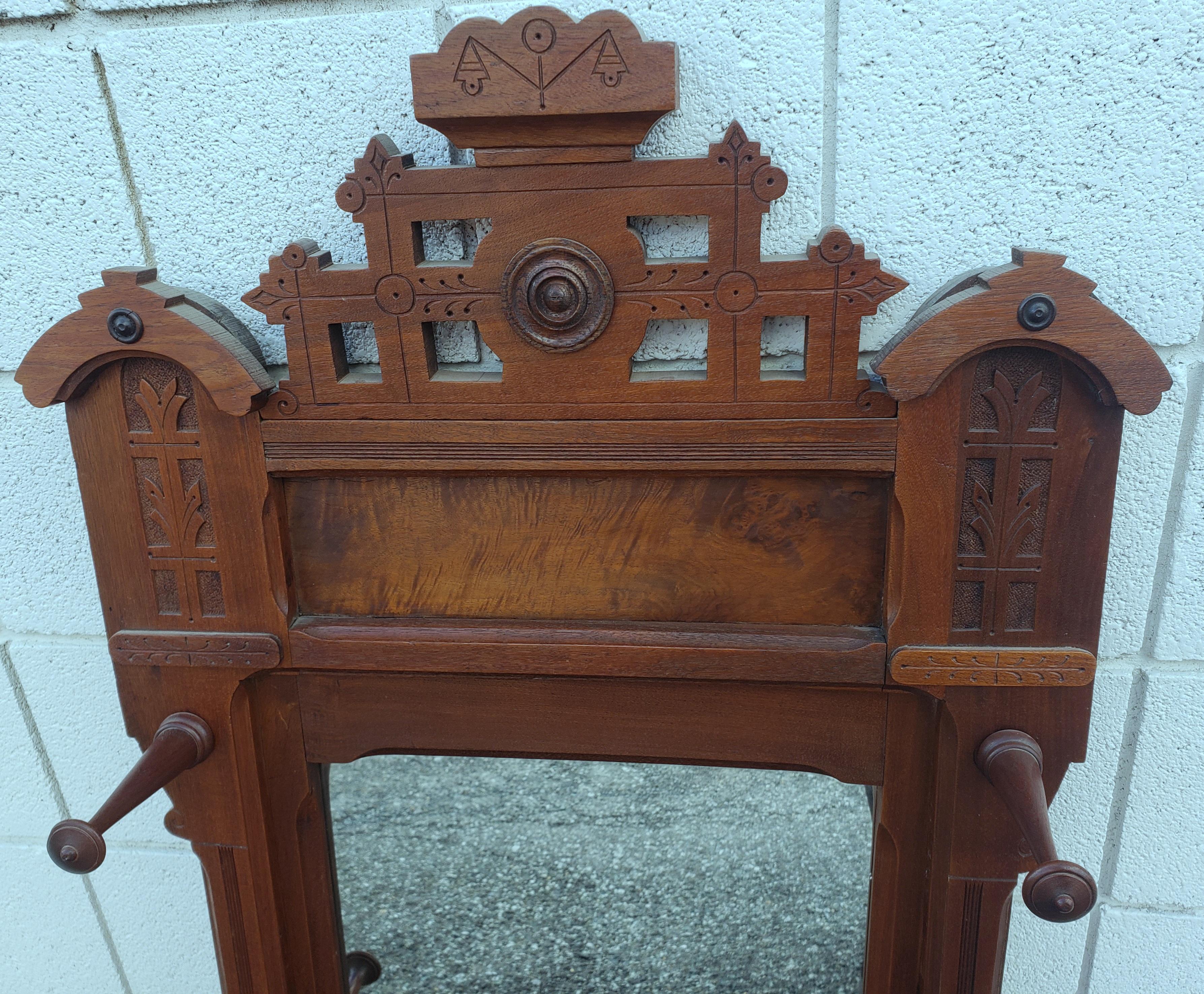  1880s Eastlake Walnut Wall Mirror with Hats Pegs In Good Condition For Sale In Germantown, MD