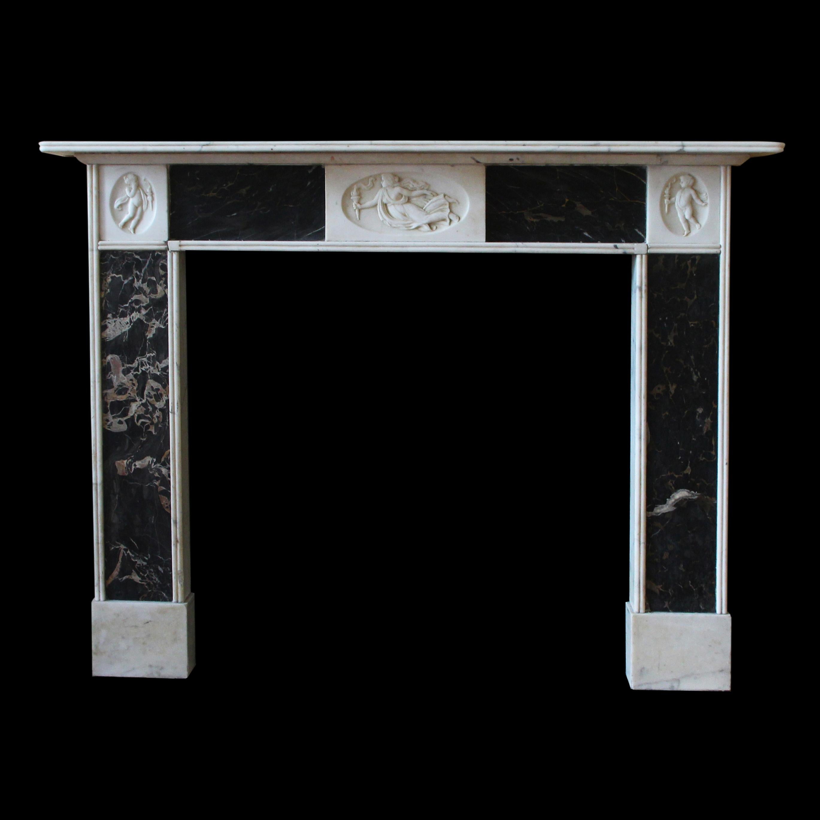 Italian black and gold Portoro marble mantel, crafted in the distinguished English Regency style. Adorned with skillfully carved statuary marble motifs depicting figures clutching torches, this mantel is a true work of art. The black marble's rich