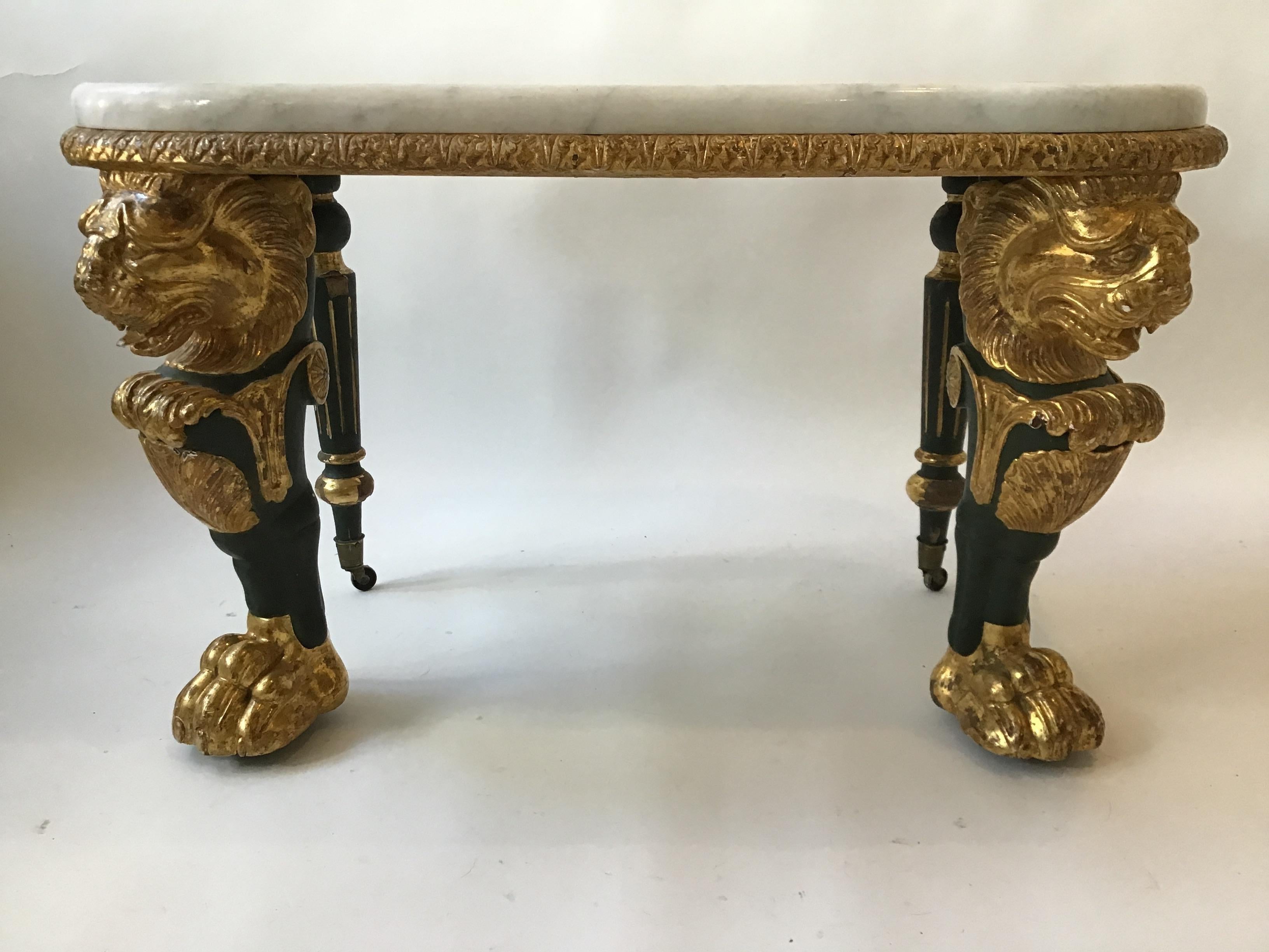 1880s French gilt lion legged table with marble top. Hand carved wood. From a Park Ave apartment.