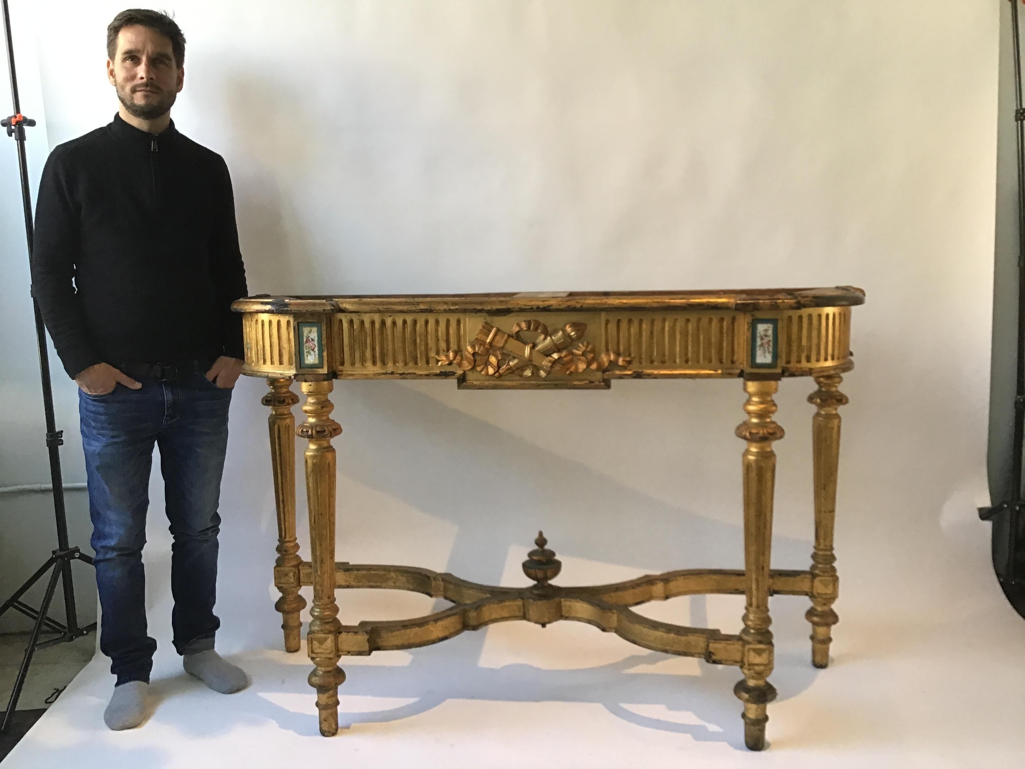 1880s gilt wood console with hand painted ceramic plaques. No top. Some small pieces of molding missing as seen in images 10 and 14.