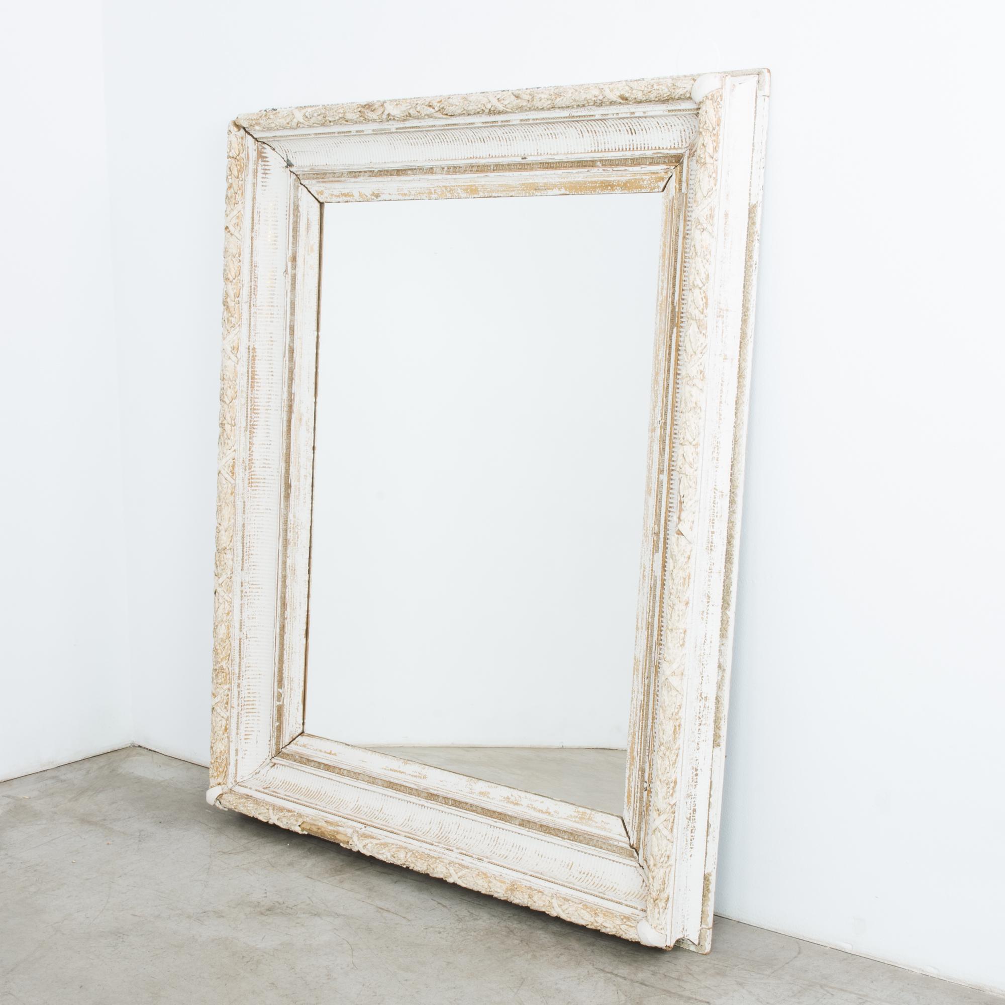 Made in France, circa 1880, this exceptional mirror with a wooden frame will be an elegant accent for any space. The different orders of ornamentation form a beautifully layered composition. The meander, reeding, and carved foliage hint at its