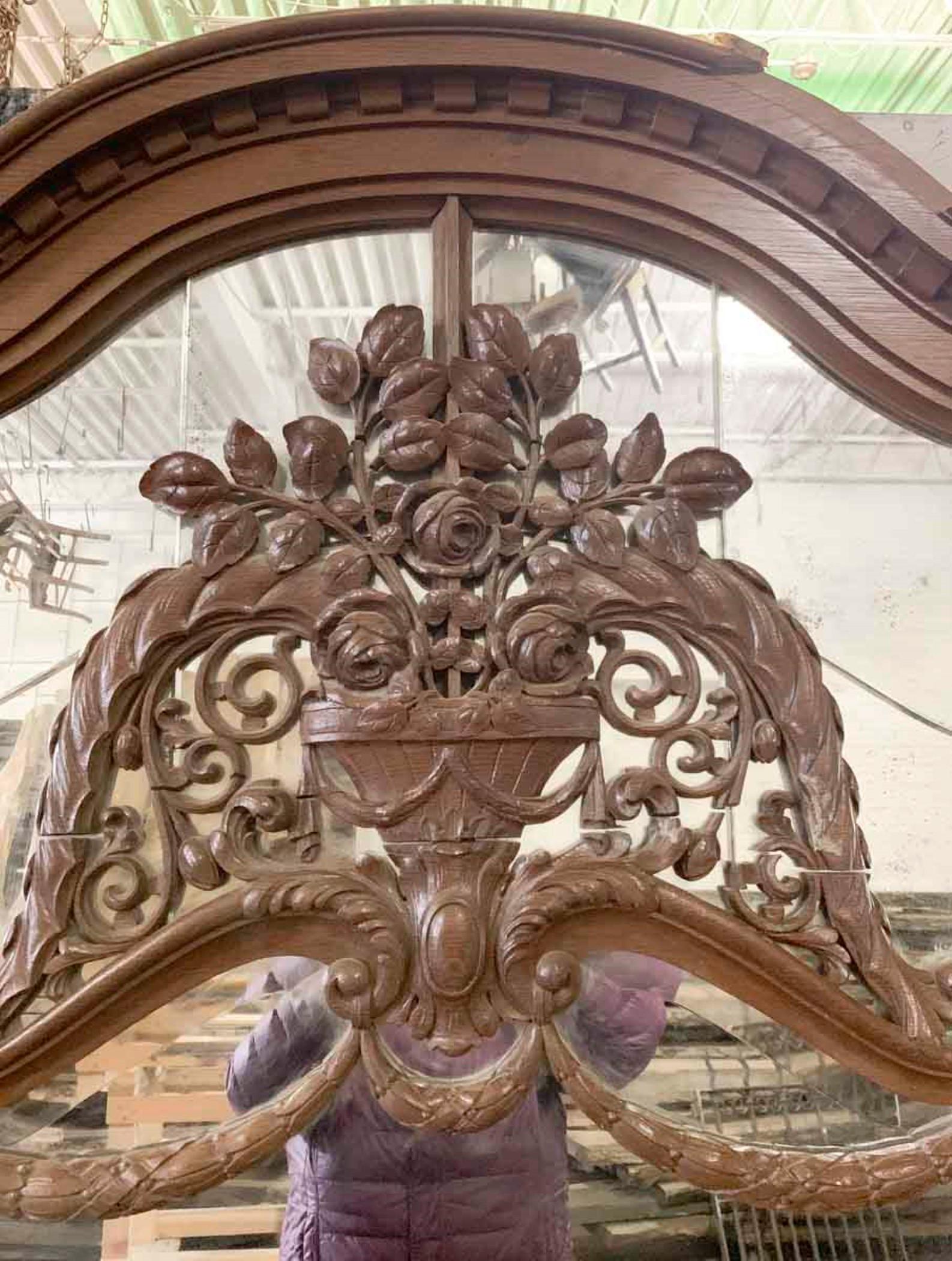 1880s large oak over mantel mirror that also can be used as a floor or wall mirror. Hand carved frame with floral details. Original beveled mirror with light distressing. Some minor cracks in the decorative glass pieces and general wear in the wood