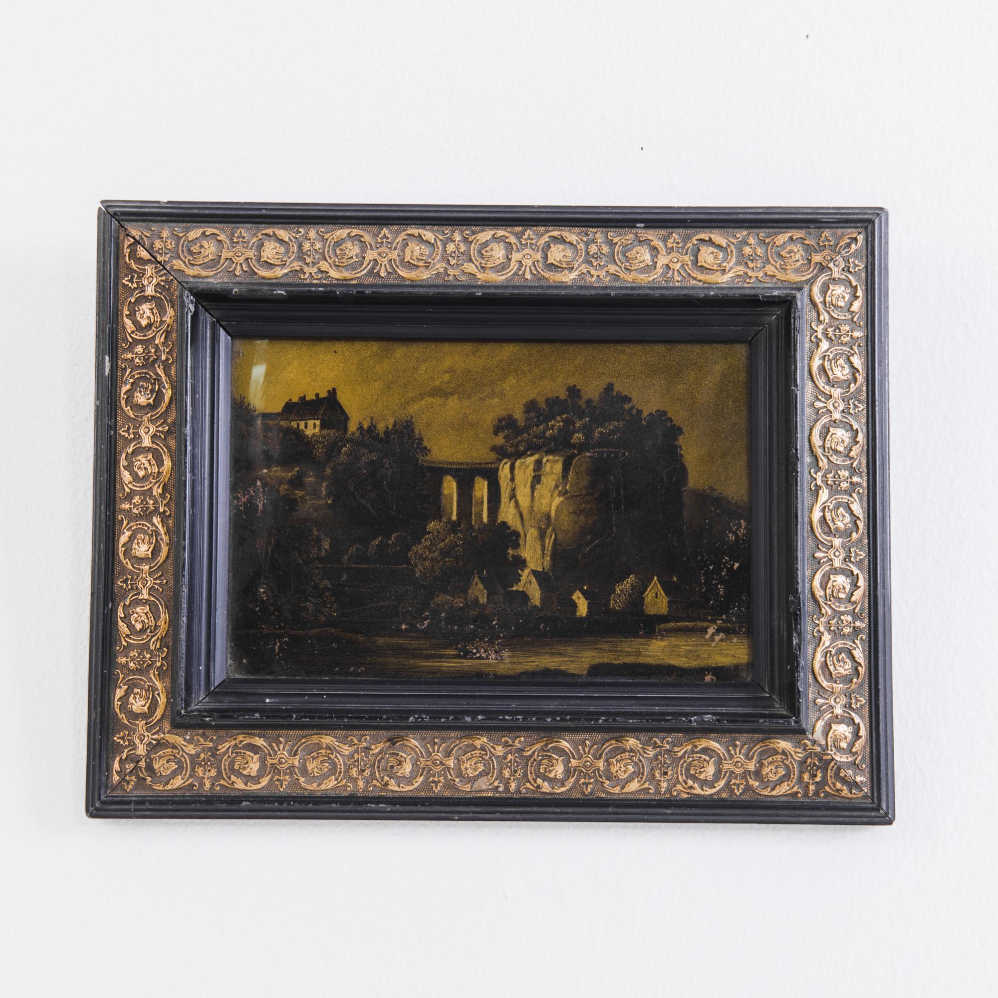 A landscape painting with giltwood frame from France, circa 1880. A scene depicting a village and cliff, rendering in an earthy ochre, is elaborated by a floral giltwood frame.