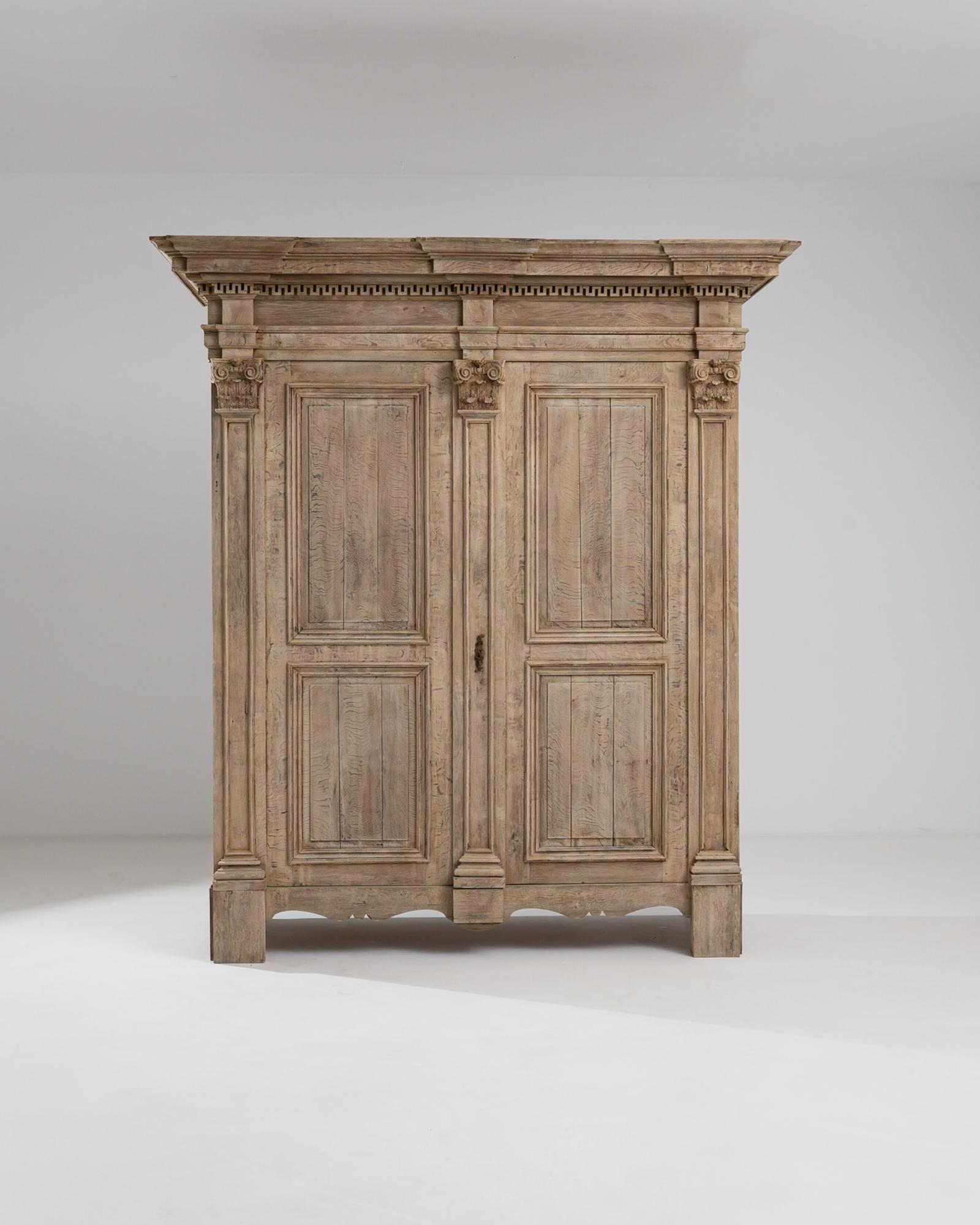 A wooden cabinet from 1880s France. Two hulking doors swing outwards to reveal a vast storage space. The door’s neoclassical columns create a curiously pleasant asymmetry, with wider compartments on the right and narrower on the left. A network of