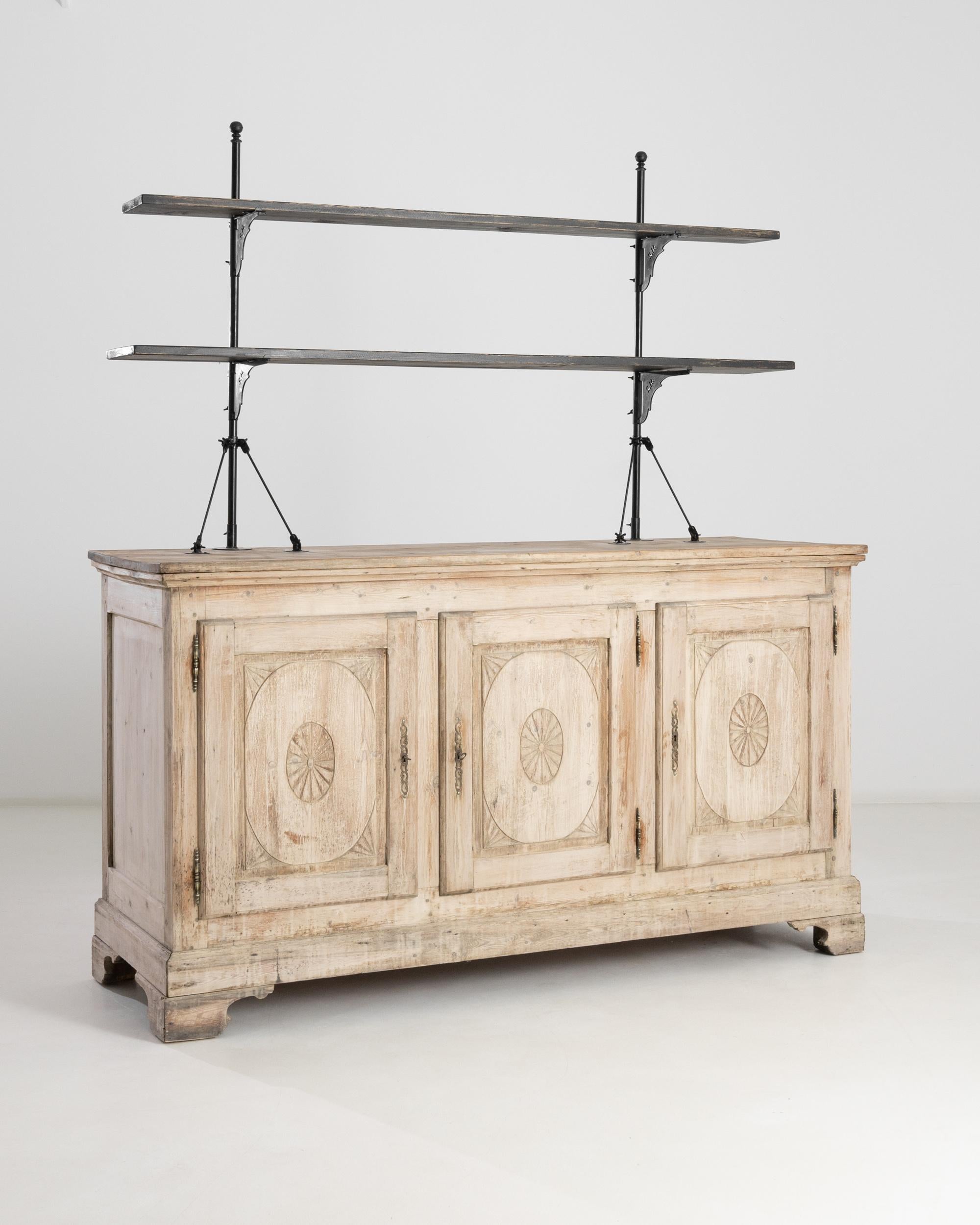 This antique display cabinet harks back to an era of exploration and discovery. Made in Belle Époque France, circa 1880, the sandy natural oak of the lower cabinet evokes uncharted beaches, while the stark, minimalist profile of the upper shelves