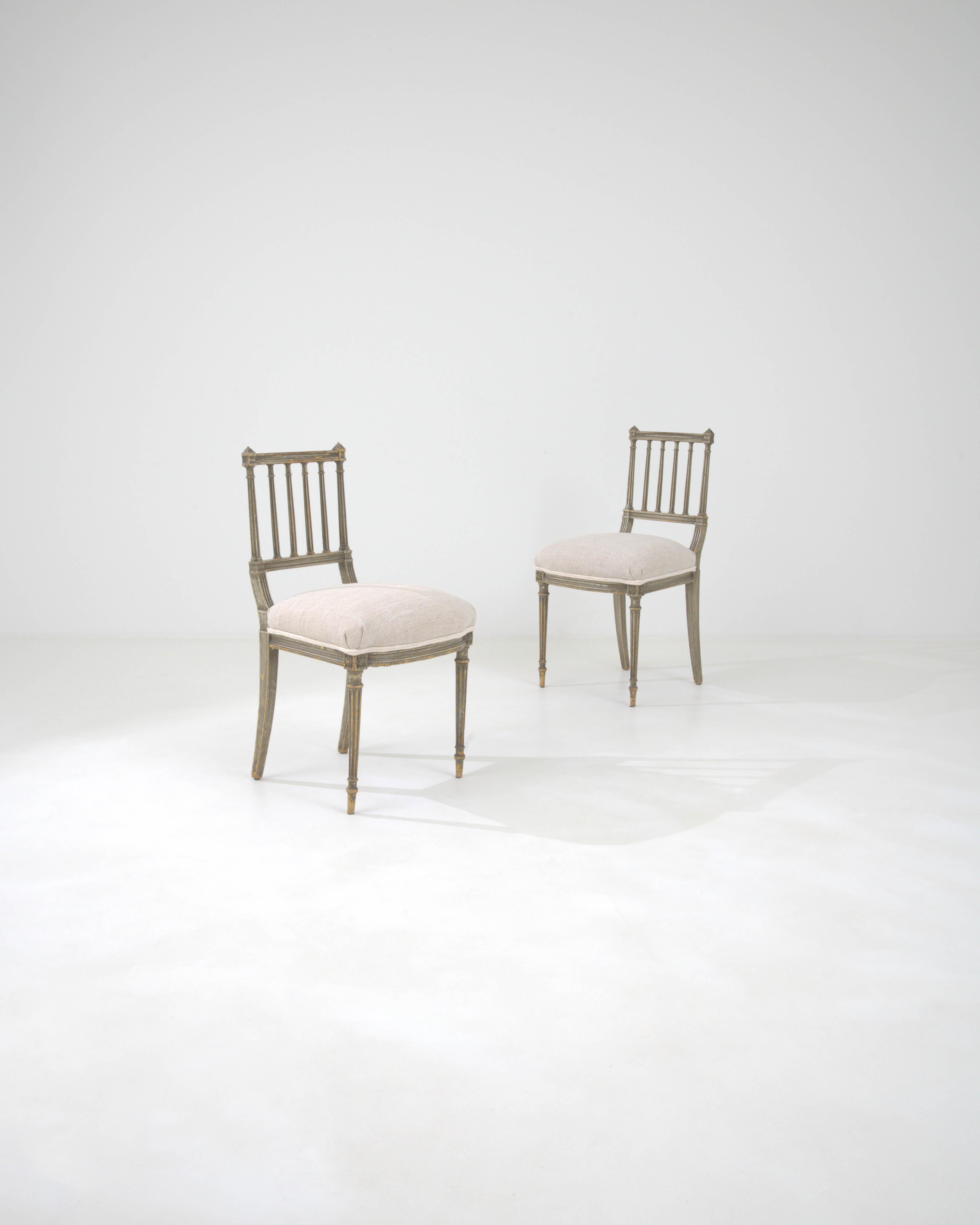 This exquisite pair of 1880s French dining chairs is a testament to the enduring elegance of 19th-century design. Each chair showcases the meticulous craftsmanship of the era with beautifully turned and fluted legs leading up to a classic,