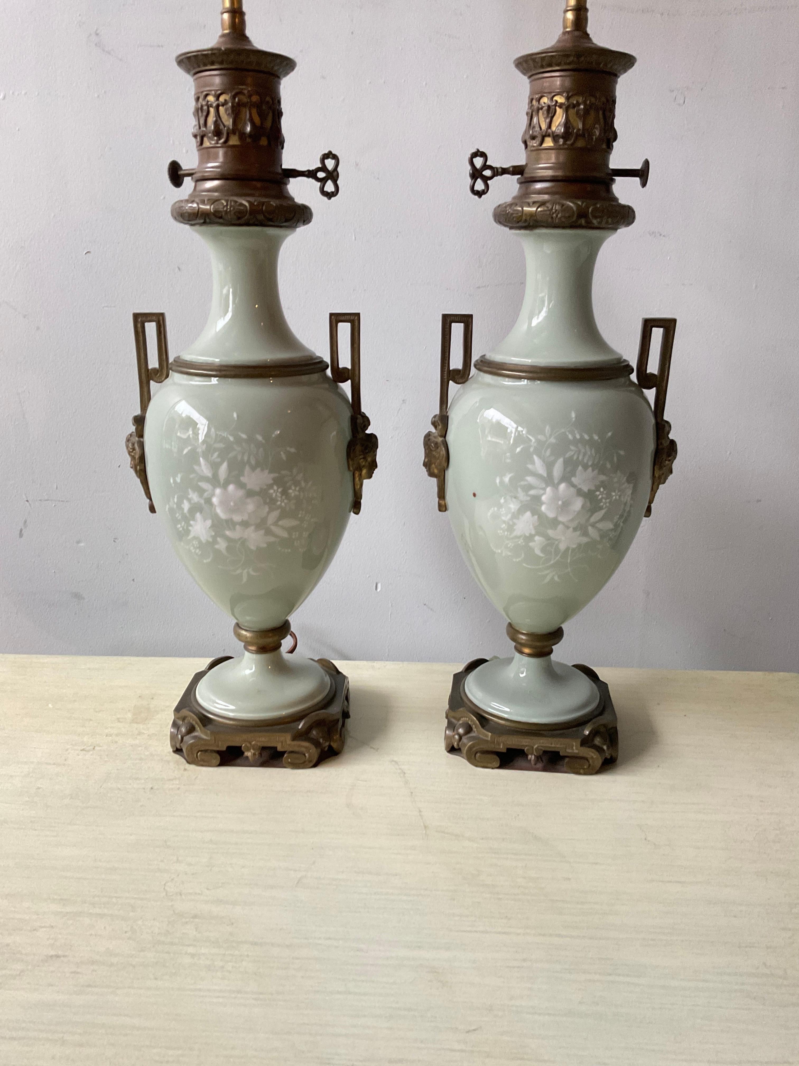 Pair of 1880s French porcelain pate sur pate lamps Height of 33” is to top of the finial.
Lamps need rewiring.