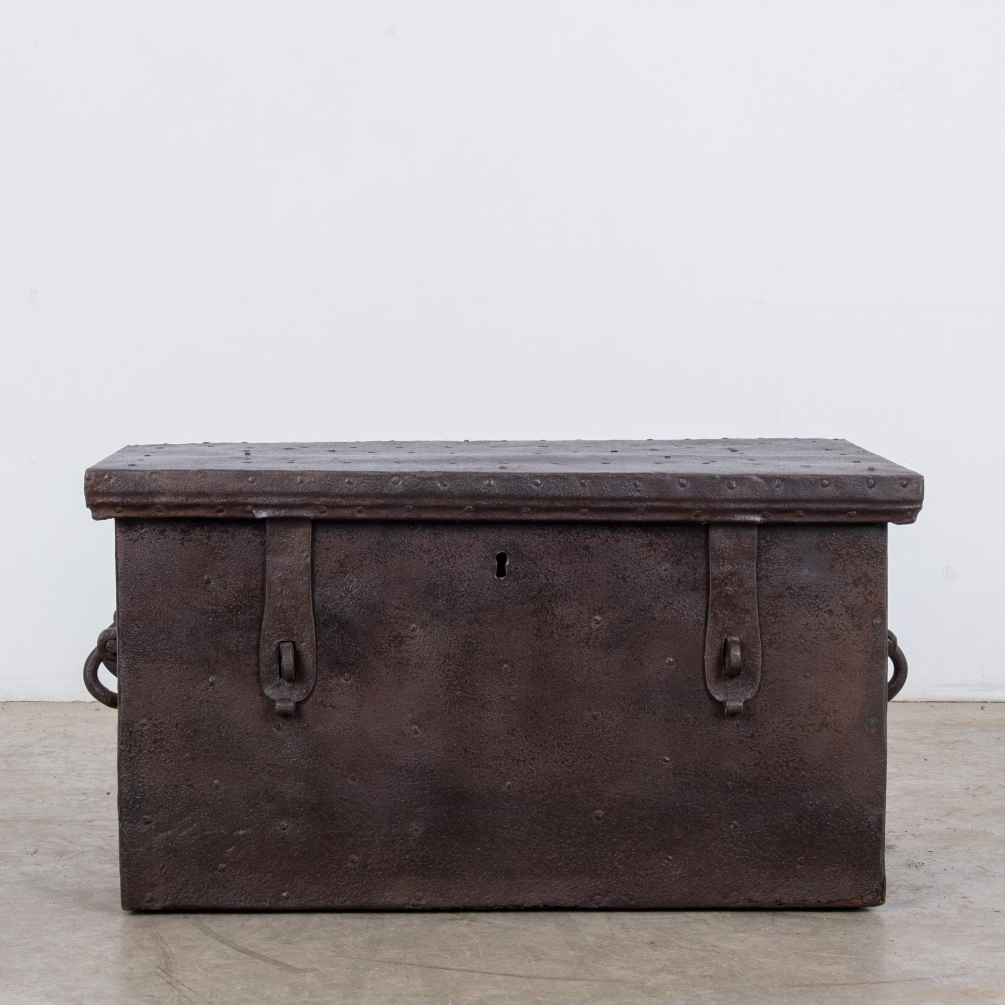This wooden trunk with a full metal finish was made in France, circa 1880, and displays an exquisite, rich patina. Standing at fourteen inches high and constructed with a flat top, this piece is typical of trunks produced in the nineteenth century