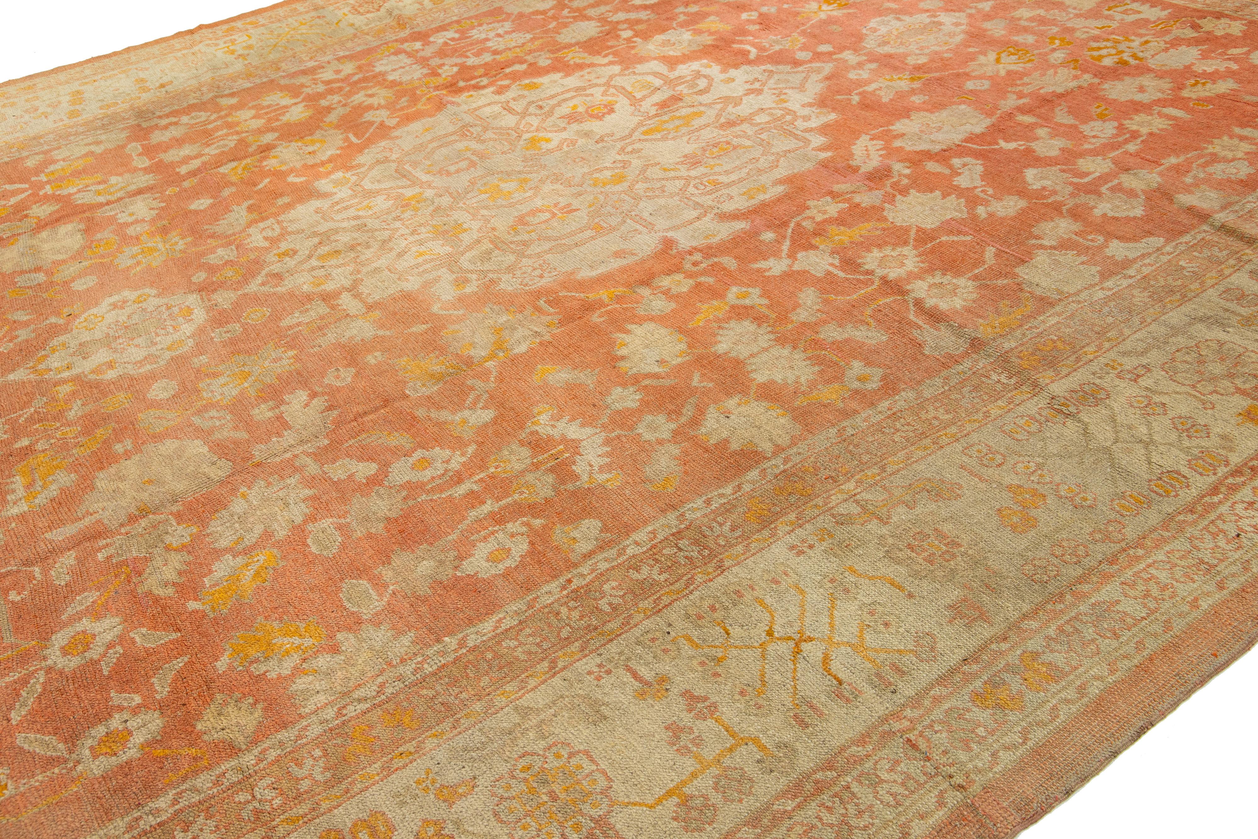 Hand-Knotted 1880's Handmade Orange Turkish Oushak Wool Rug Featuring a Medallion Motif  For Sale