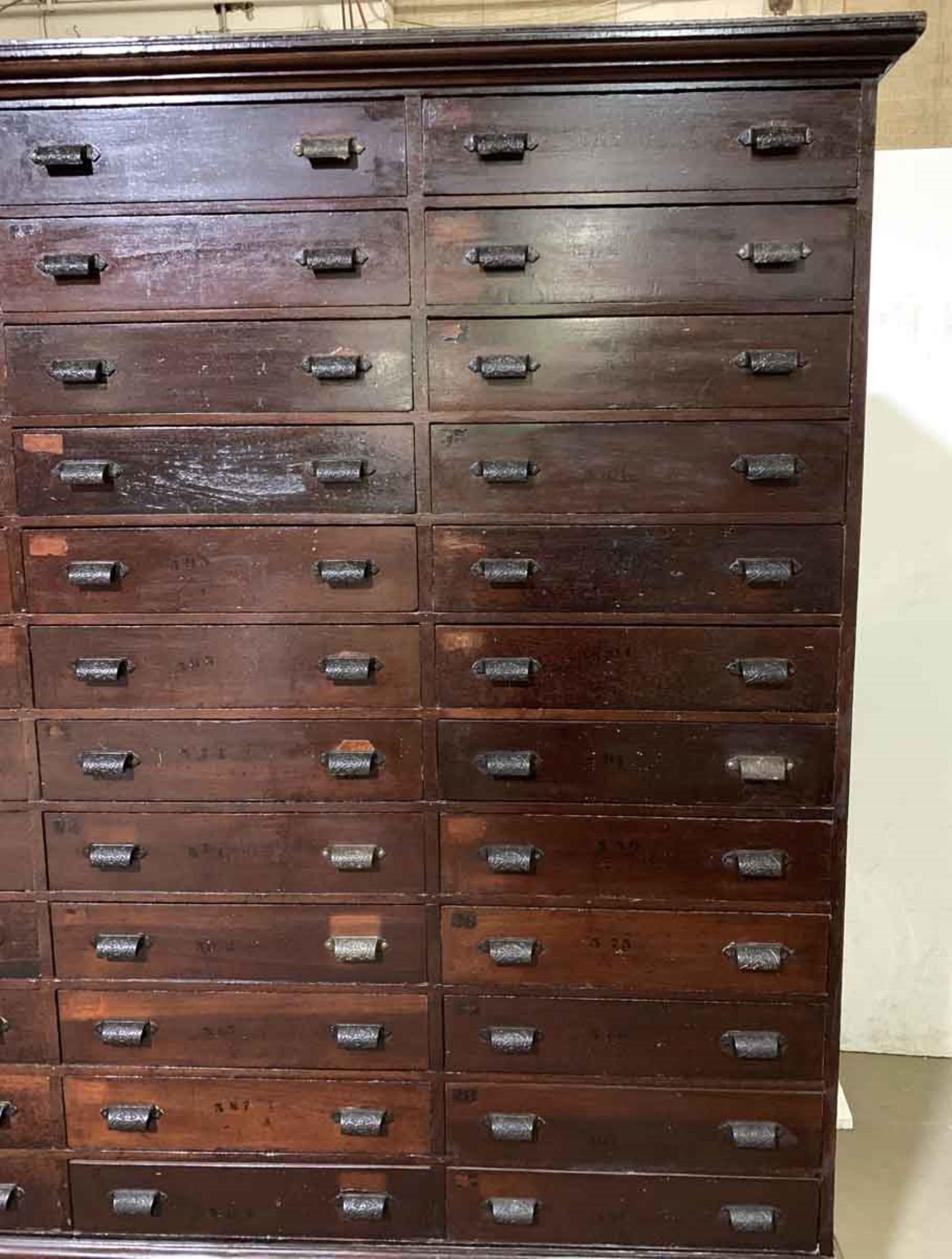 1880s dark wood tone Industrial cabinet from a western Massachusetts factory.. There are 36 drawers with the original hardware. Recently refinished. Please note, this item is located in one of our NYC locations.