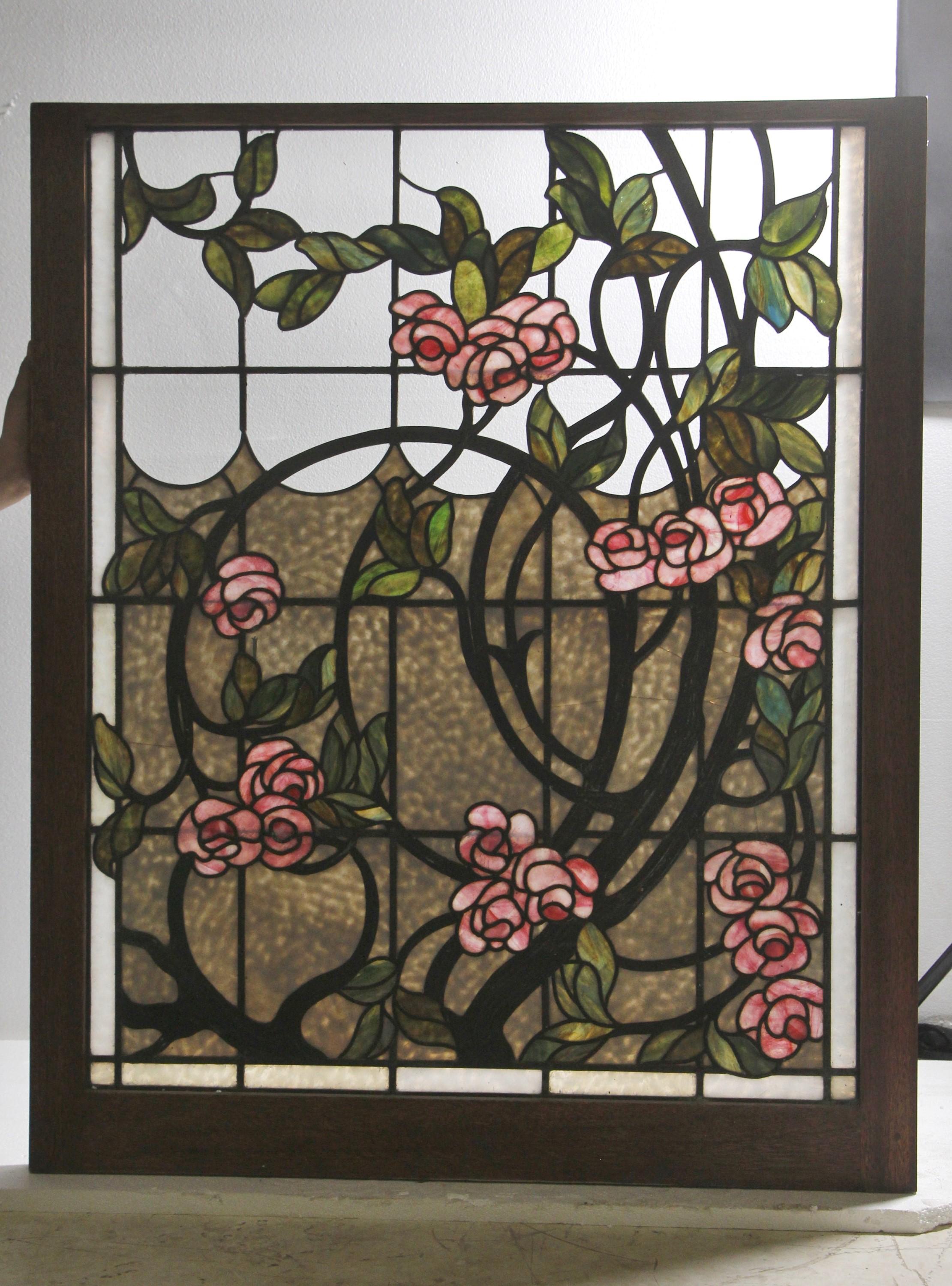 Set (top and bottom) of 1880s stained glass windows done in a vibrant blue lake, pink water lilies, green leaves, and black vines design. The bottom part shows the water lilies growing up from the lake and encompass the sky. Both windows are mounted