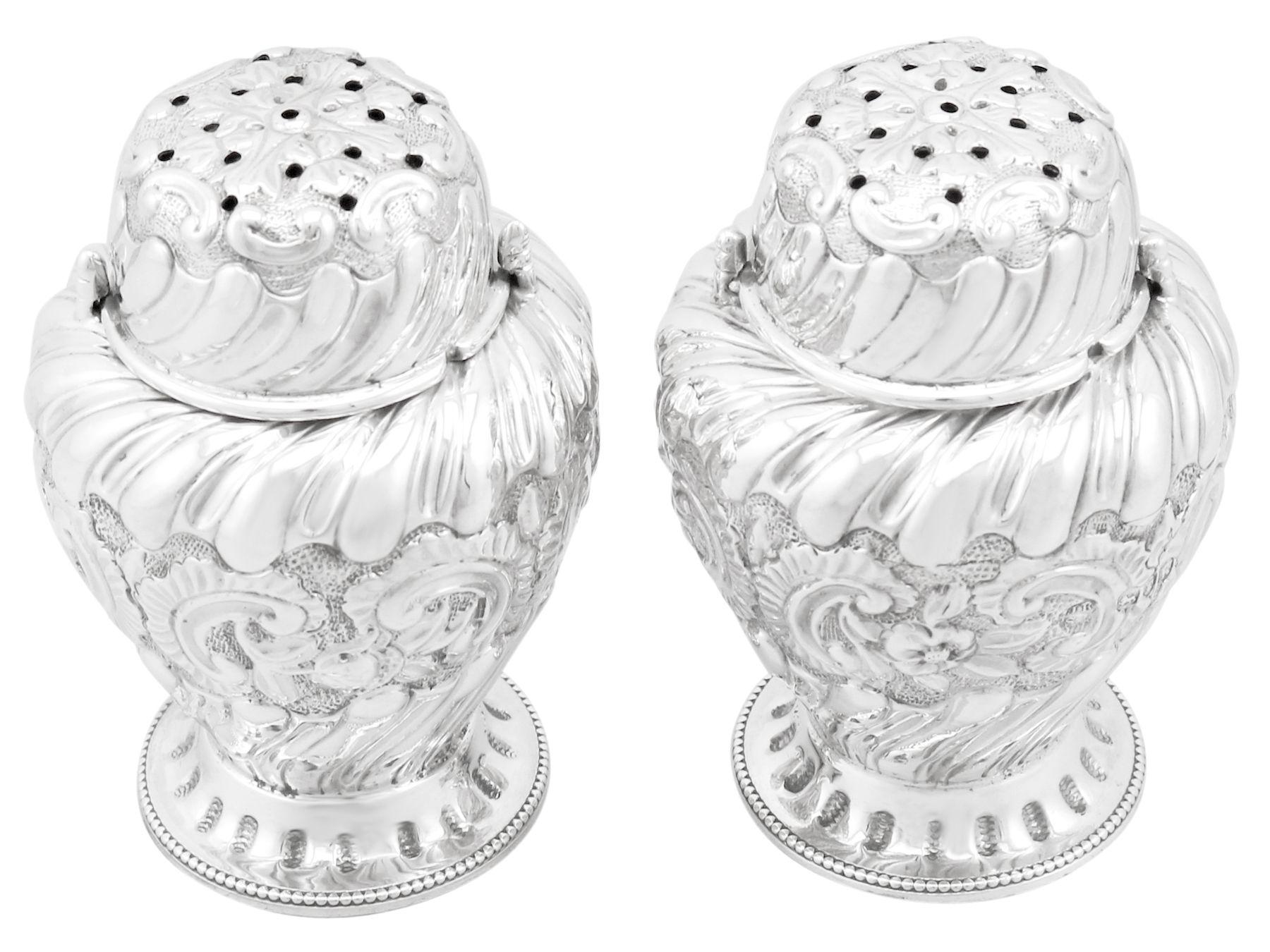 A fine and impressive pair of antique Victorian English sterling silver condiment shakers; an addition to our silver tableware collection

These impressive antique Victorian English sterling silver condiment shakers have an inverted pear shaped