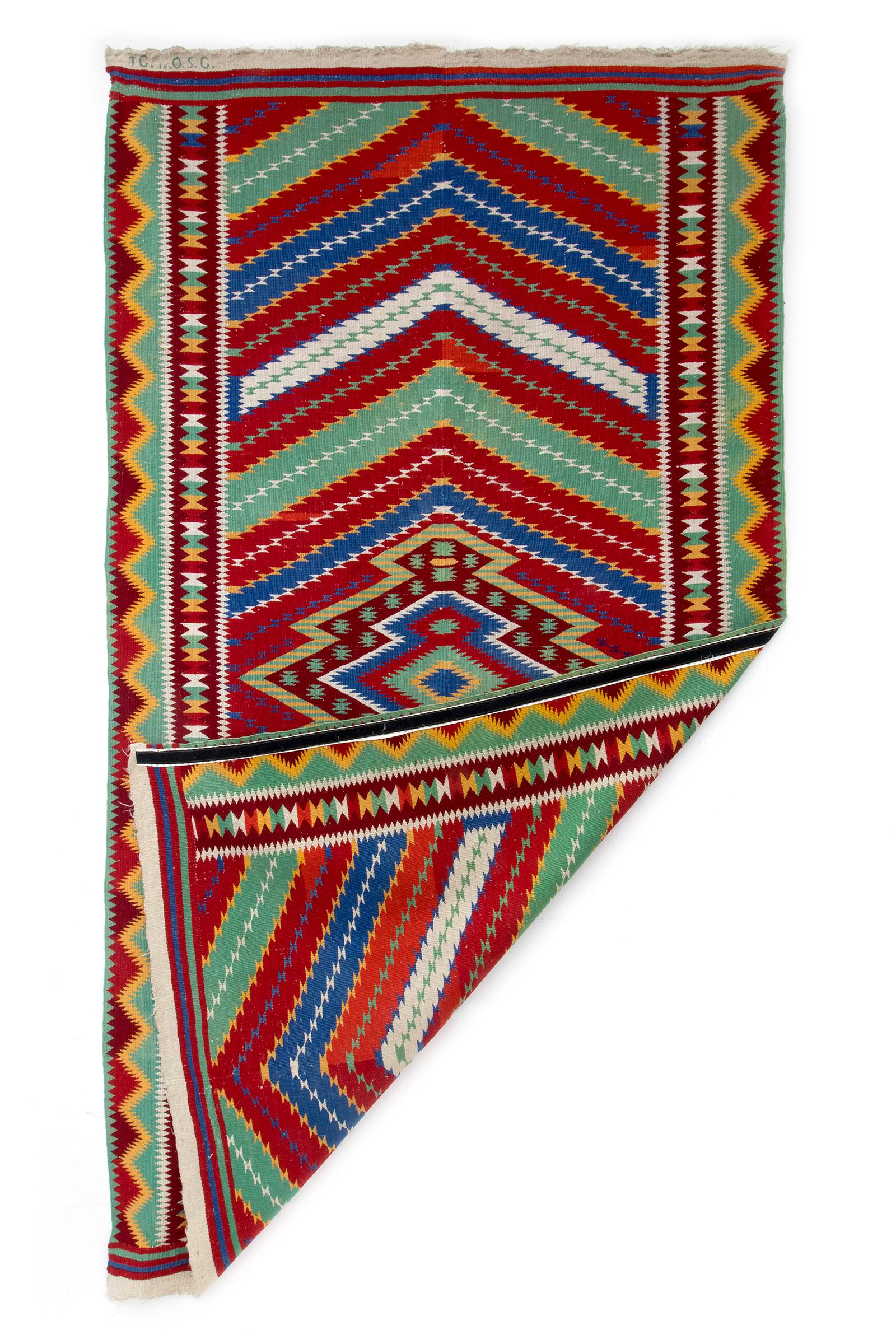 Antique circa 1880 Rio Grande Saltillo Sarape, hand woven of Germantown yarns in colors of red, green, golden yellow, blue, and white in a diamond pattern, fringed at either end.  Ready to hang on the wall with custom velcro mount (fully removable).