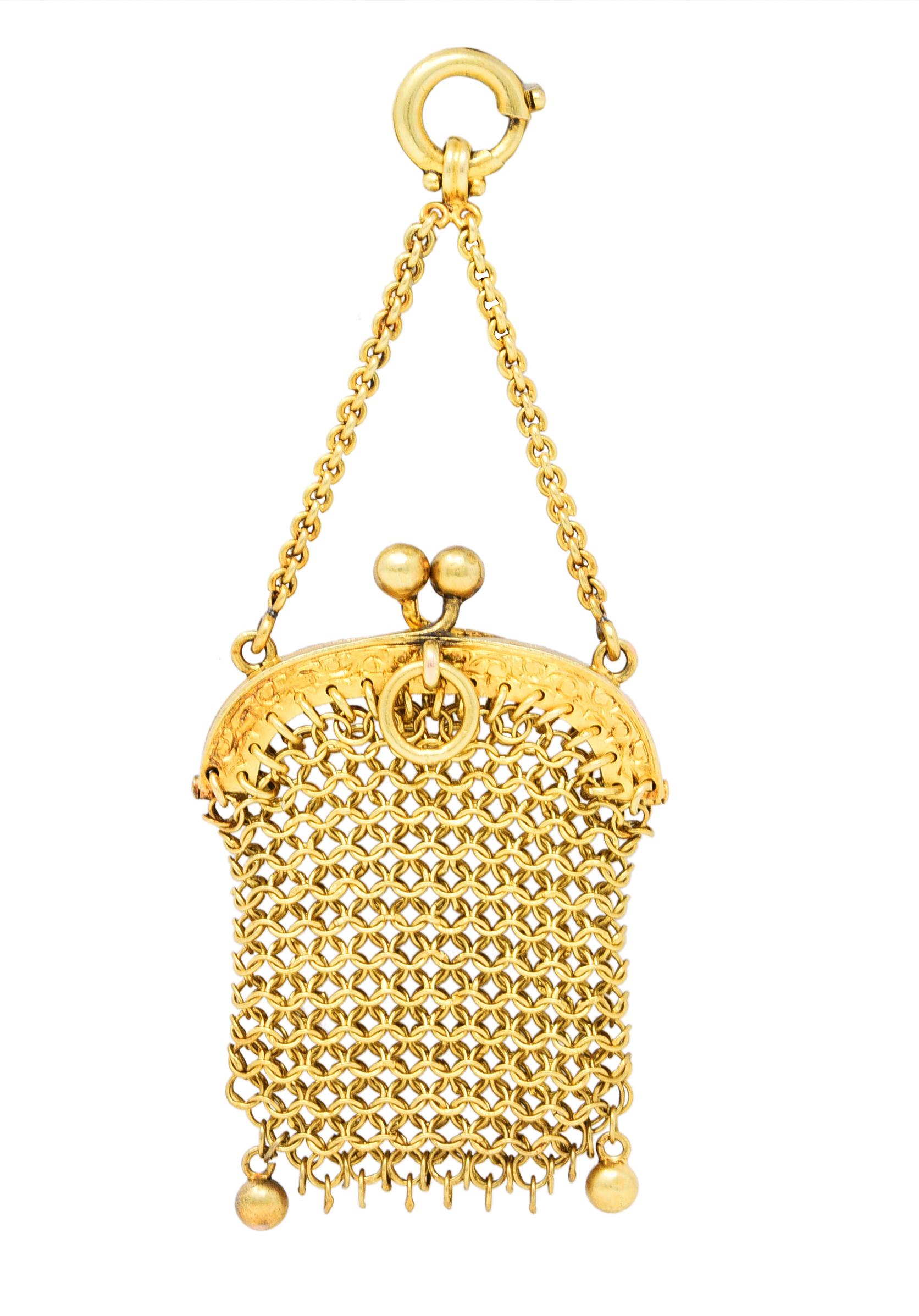 Designed as a miniature chatelaine purse comprised of a finely interwoven gold chain mail

Opens on a hinge via bypass clasp that is hand-engraved with scrollwork

Suspending from swagged chain and terminates as a spring ring clasp

With maker's