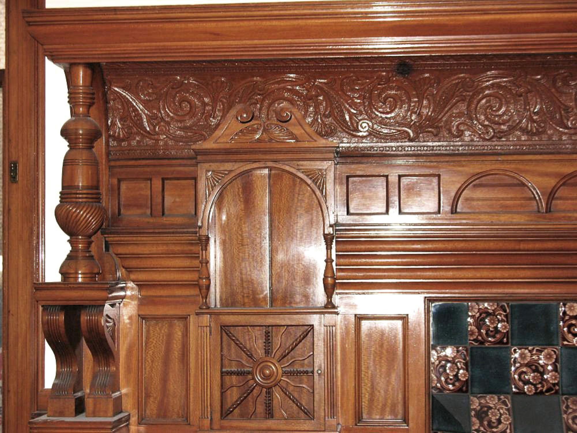 Carved panels decorate the façade of this 1880s Victorian mantel as well as turned columns and stately corbels. Carved side panel and original tiles not included. Please note, this item is located in our Scranton, PA location.