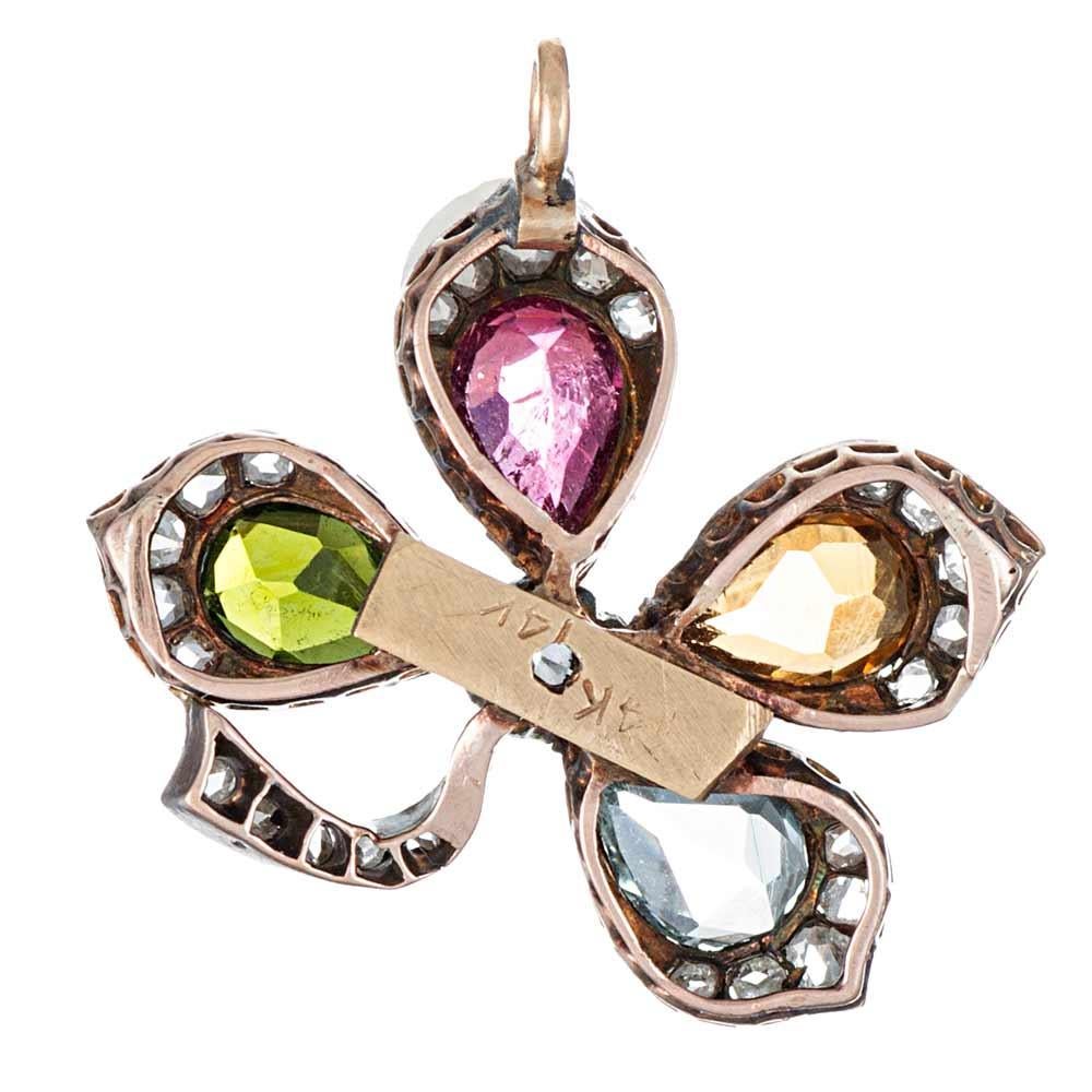 Bestow upon your beloved a bit of good luck with this gemstone and diamond four leaf clover pendant, set with aquamarine, citrine and pink- and green tourmaline. This lovely little treasure measures approximately 1 inch by 3/4 of an inch. 14k yellow