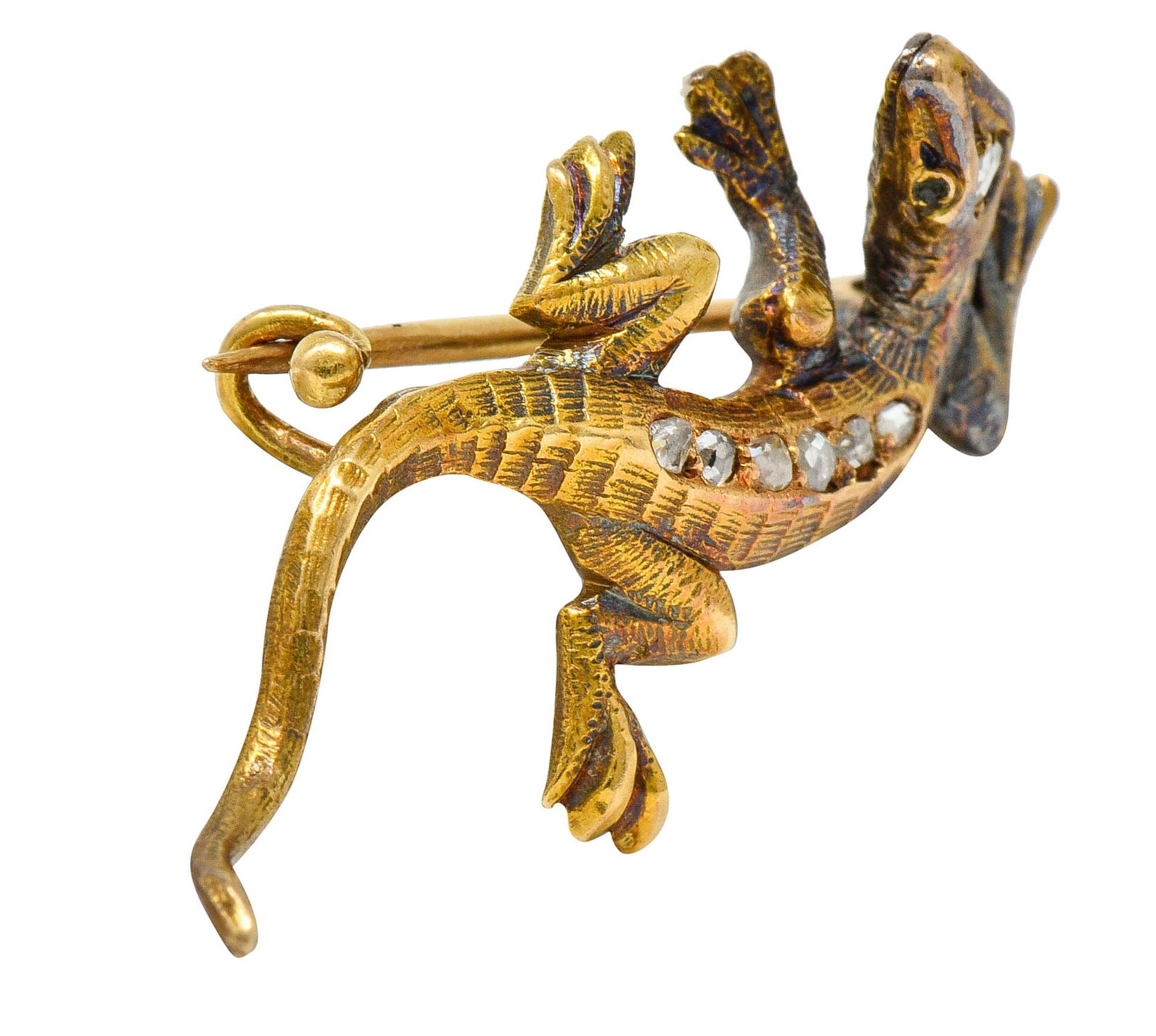 Designed as a small but animated lizard

With hatched lines and a ridged texture

Accented by rose cut diamonds weighing approximately 0.12 carat

Completed by a pin stem with closure

Tested as 18 karat gold

Circa: 1880s

Measures: 11/16 x 1 1/4