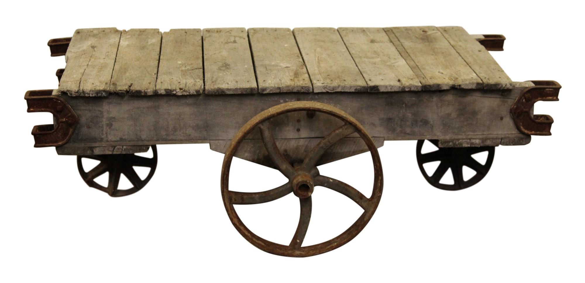 Made in the late 1800's, this wood factory cart has a rustic look featuring wood slabs and cast iron wheels. The natural rust and wear with age adds to its authenticity along with it's original patina. There are many possibilities now for it such as