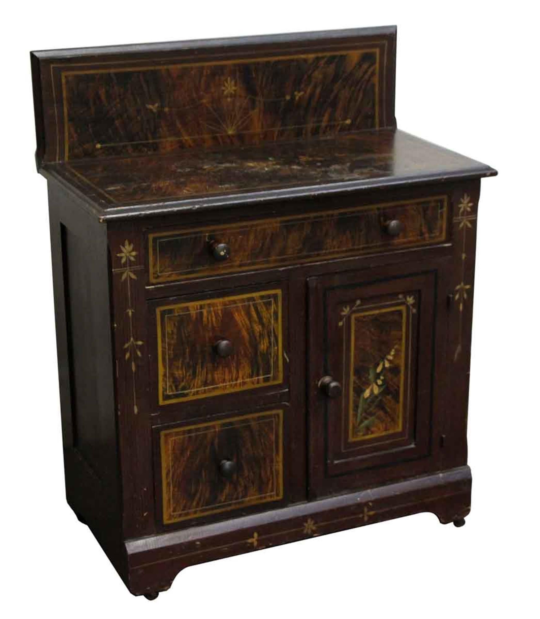 1880s dark wood tone wash stand with a hand painted decorative finish. This shows wear and has some chips in the wood from age and use. This can be seen at our 400 Gilligan St location in Scranton, PA.
