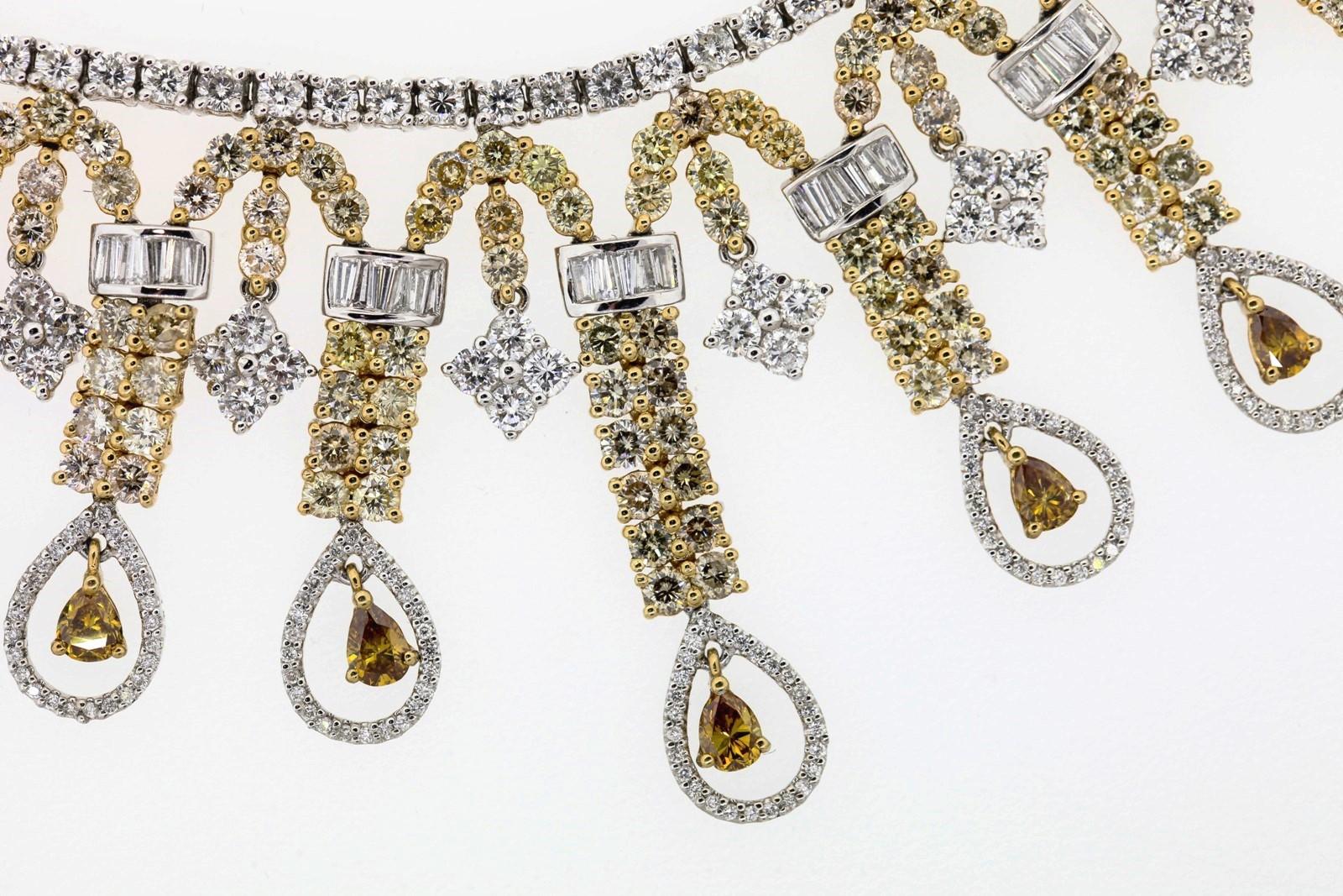 Fantastic and one of a kind brilliant Diamond necklace of 18.82 carat with a medley of shapes and colors.  The partial Riviera of round white diamonds taps eight falling arches of light Yellow and White diamonds, accented with Baguette and Square