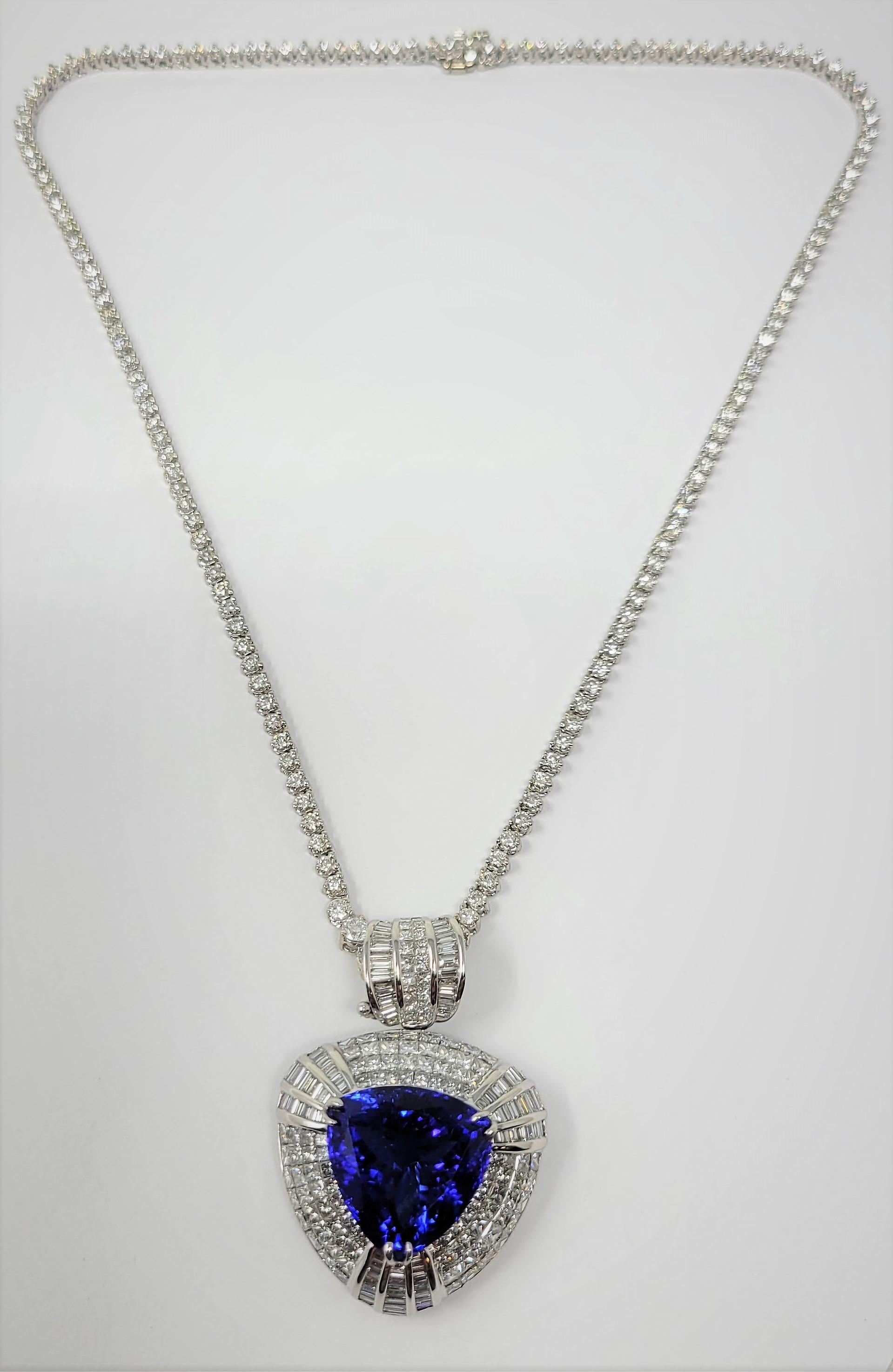 Versatility and beauty!  This trillion tanzanite enhancer with 18.82 carat tanzanite and 7.85 carats of diamonds is set in 18 karat white gold. The tanzanite is accented with both invisible set and baguette diamonds.  The separate straight line