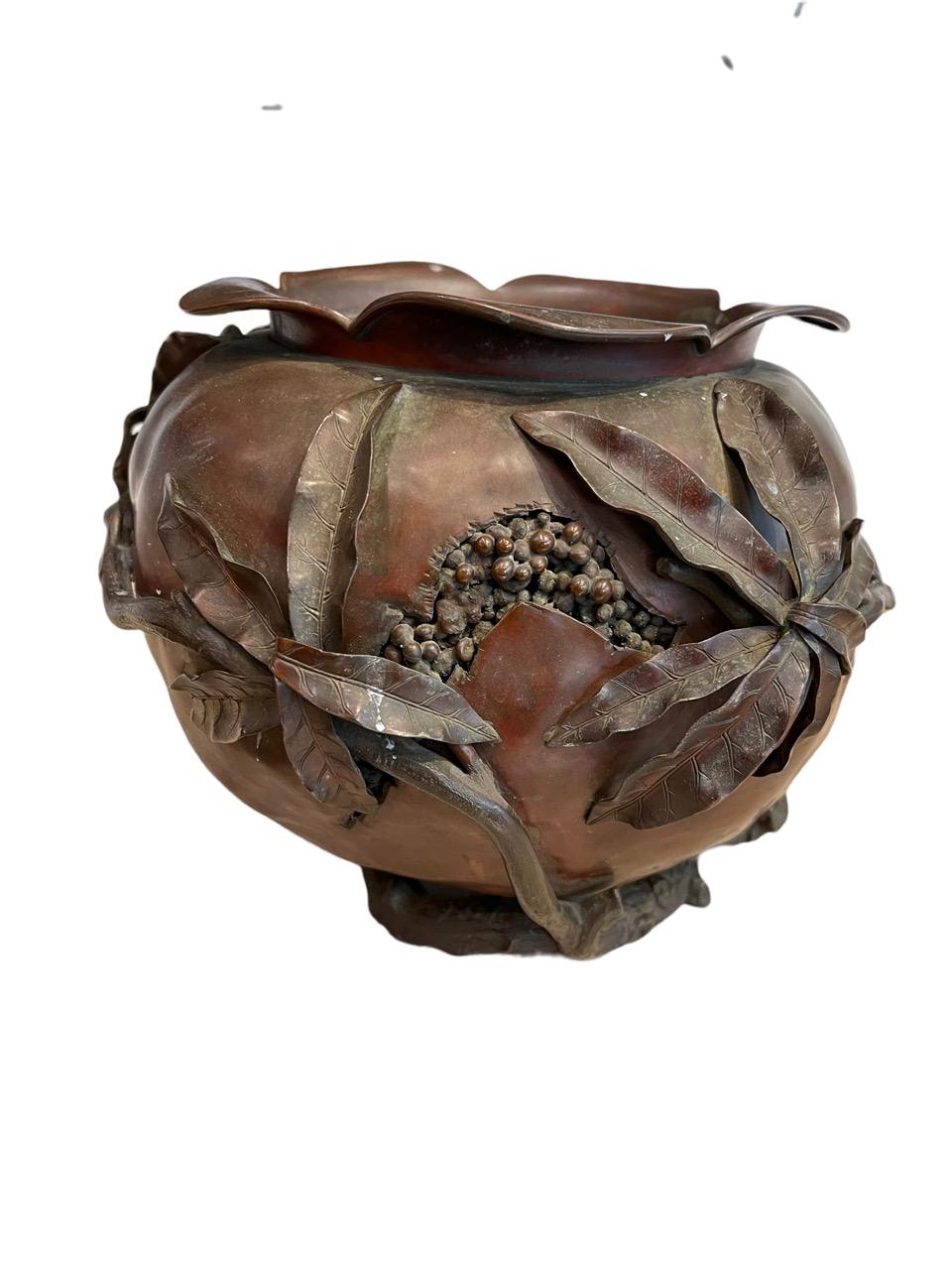 1883 Gorham bronze aesthetic pomegranate vase. Pomegranate shape with flared petal collar/rim, which is hand hammered copper with a deep red glaze. Applied branches and leaves in Bronze and the areas where the fruit has burst open to reveal the