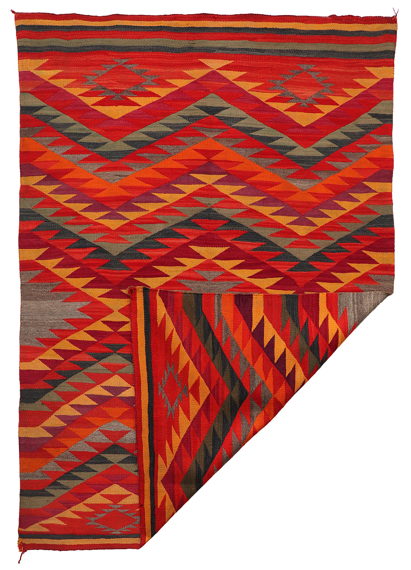 Jewel toned transitional period Navajo weaving circa 1885. Wool with aniline dyes, geometric design featuring repetition of triangles. Measures 77 x 54 1/4 inches. 

 