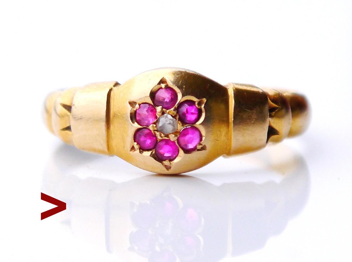 Old British ring, Egyptian revival styled with a flower on the top of the crown and  lotus Ornaments on the shoulders.

Six old European diamond cut Rubies Ø 1.5mm/ 0.015ct each and one rose cut Diamond of about the same size in the center.

British