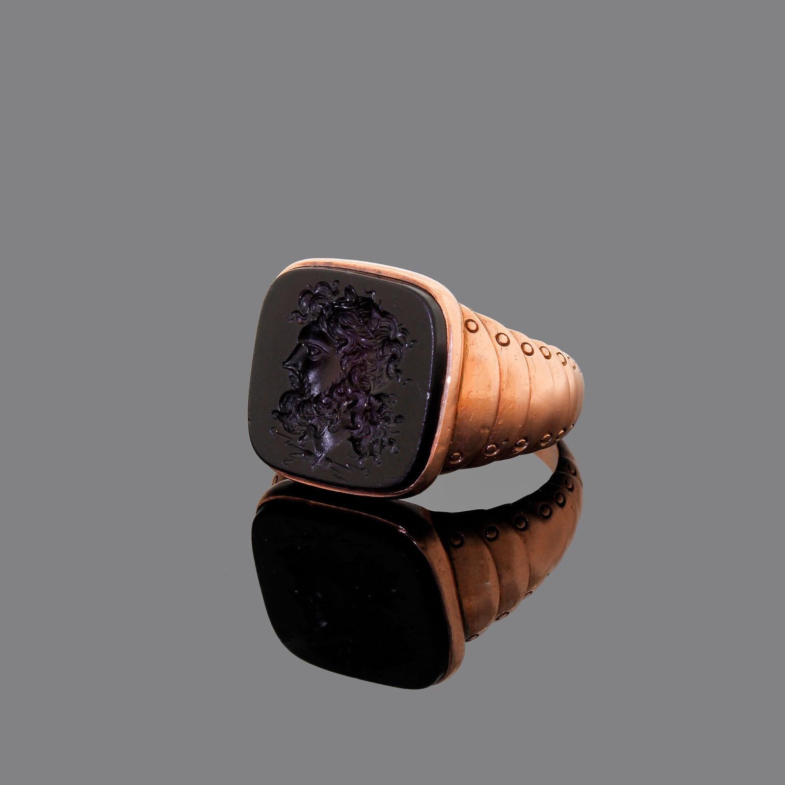 Beautiful vintage Victorian intaglio ring that dates from 1886. It has a beautiful rose gold color, very rich and is well made.
The intaglio has the Greek god Zeus which is beautifully carved the detailing under his neck is great - there are four