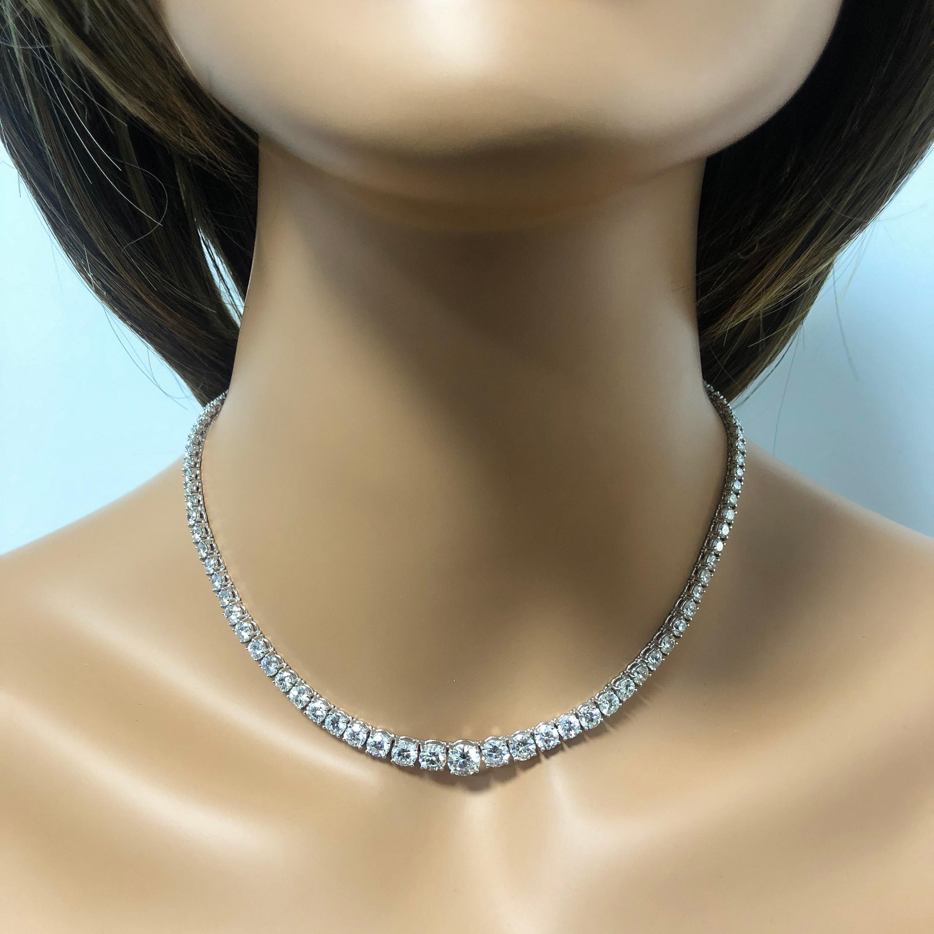 This is a very elegant necklace set with round brilliant diamonds that graduate bigger as it gets to the center. Diamonds weigh 17.82 carats, and the center stone weighs 1.04 carats with a total weight of 18.86 carats, F-G Color and VS in Clarity.