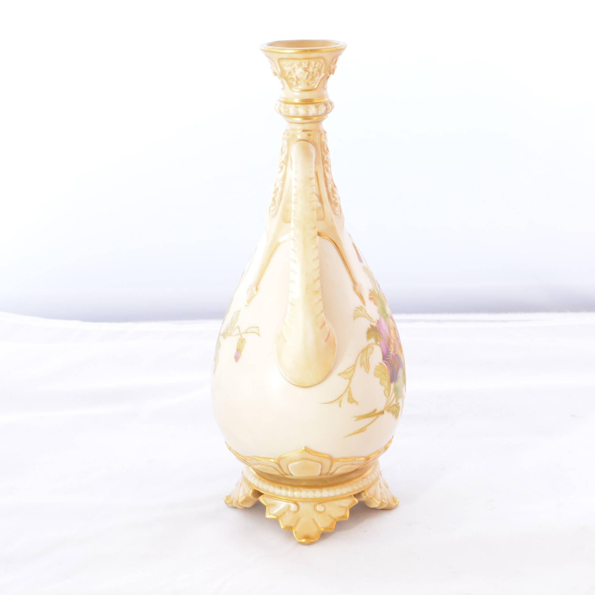 An antique English porcelain vase by Royal Worcester has hand-painted dainty purple and white pansies decorating the front - even the back is adorned with pansies in bud form. Both front and back designs on the vase are trimmed with gilt moriage.