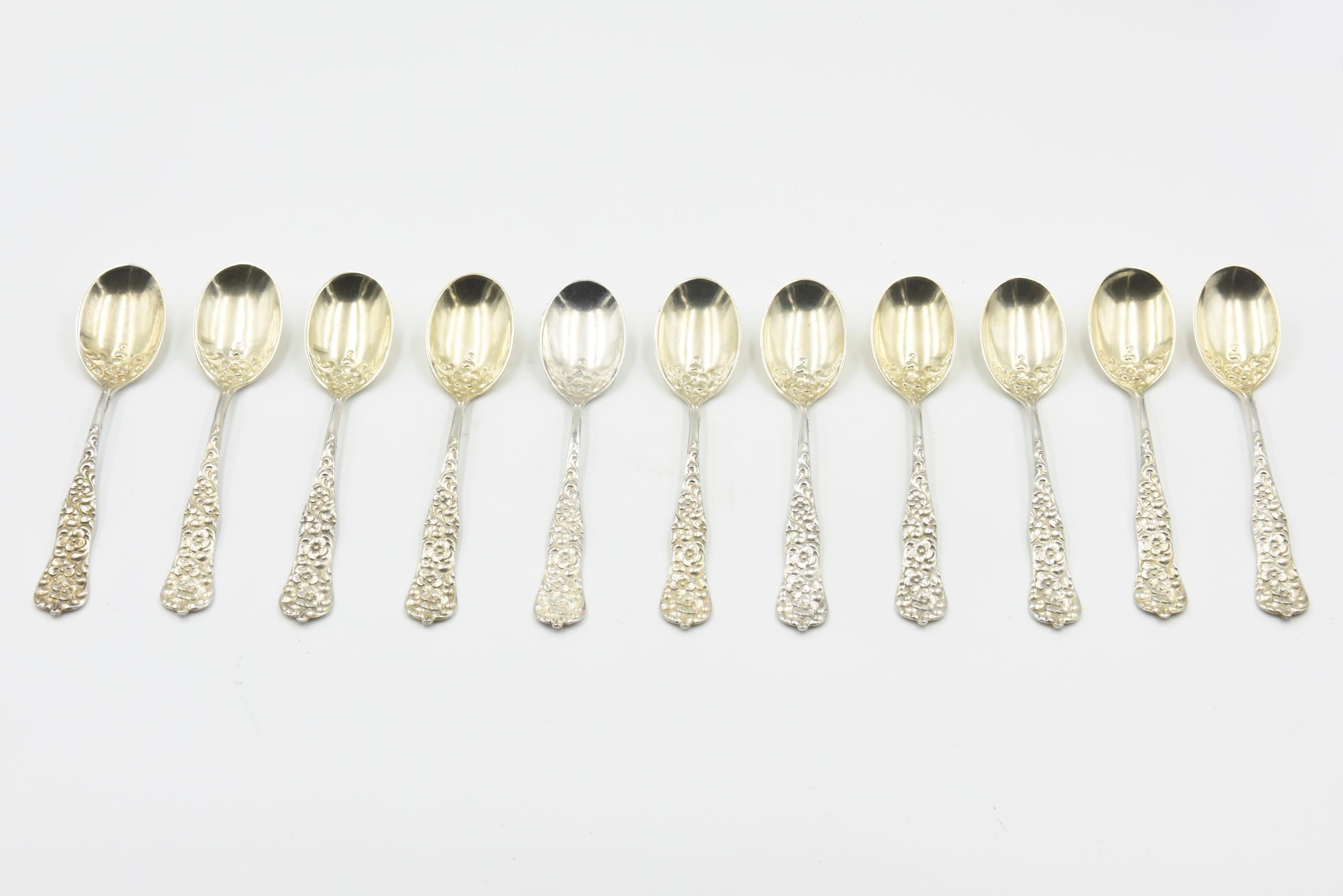 11 antique Dominick & Haff Rococo Pattern Pat. 1888 demitasse / dessert spoons designed by Gilbert L. Crowell, Jr. Retailed by Bailey, Banks & Biddle. The spoons are beautifully decorated with crisp, high relief flower and leaf decorations. The