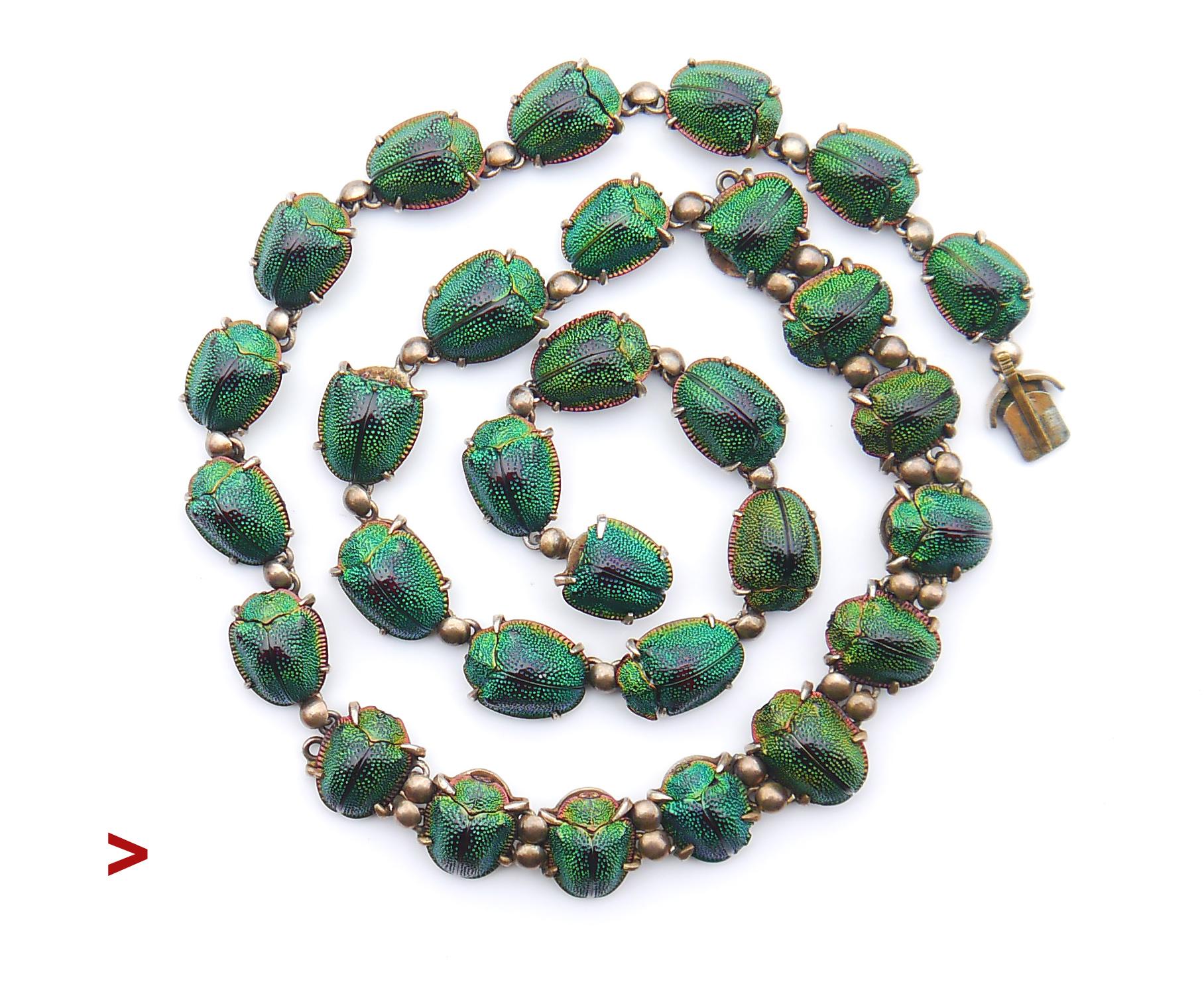 
Rare and very unusual piece of Egyptian - revival styled necklace with 30 genuine emerald Green Scarab Beetles set into gilt Silver frames.

These shimmering Tortoise beetles once were the Victorian times' species of choice to stand in for genuine
