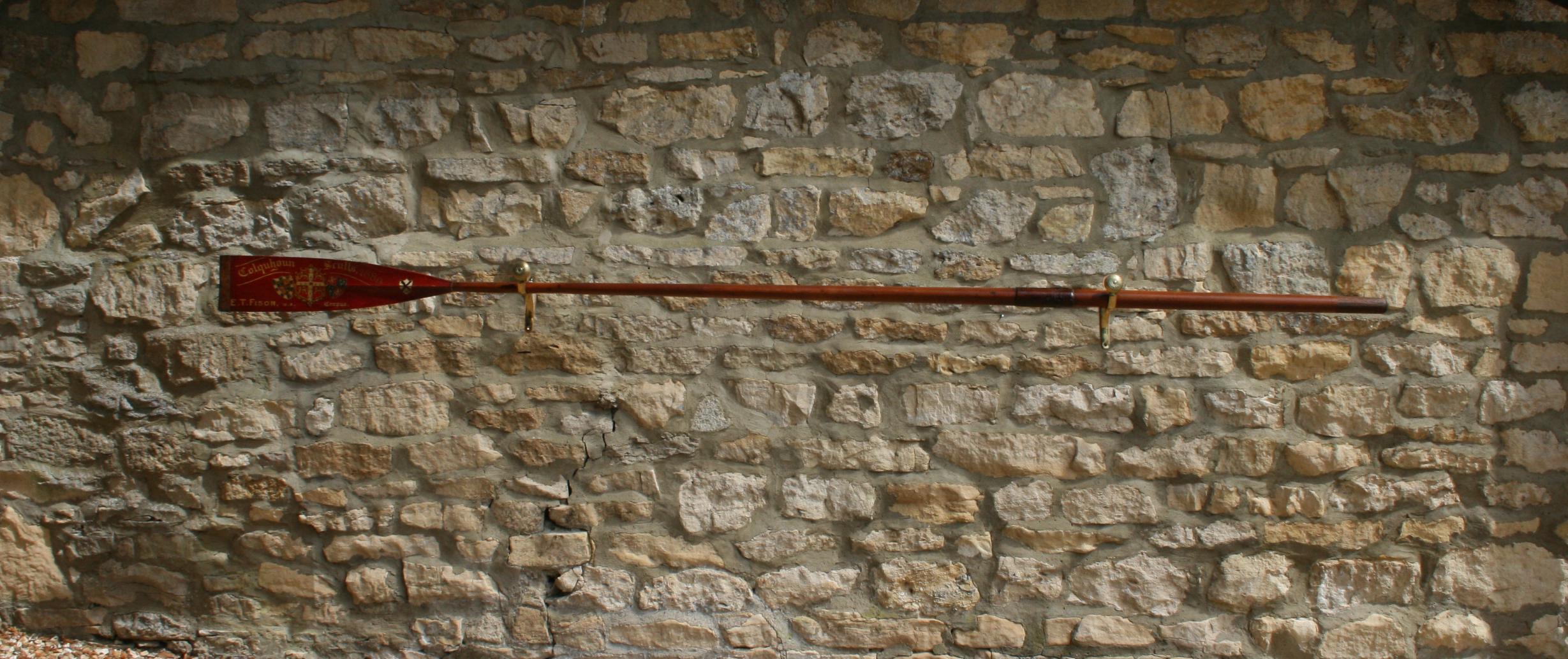 A fine pair of 1889 Colquhoun sculls trophy oars.
The full length Corpus Christi, Cambridge University sculling oar is an original traditional presentation rowing oar with gilt calligraphy and college insignias. The writing on the trophy blade is in