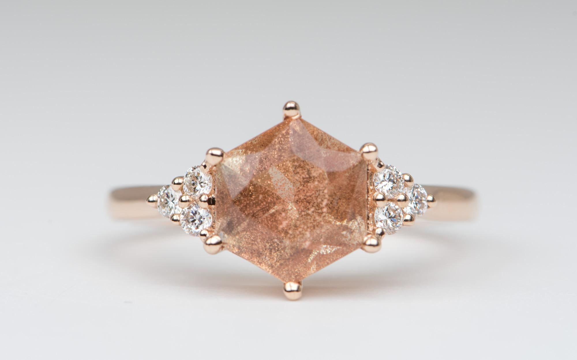 ♥  Solid 14K rose gold ring set with a hexagon-shaped Oregon sunstone in the center, flanked by three diamonds on each side
♥  The sunstone has strong 