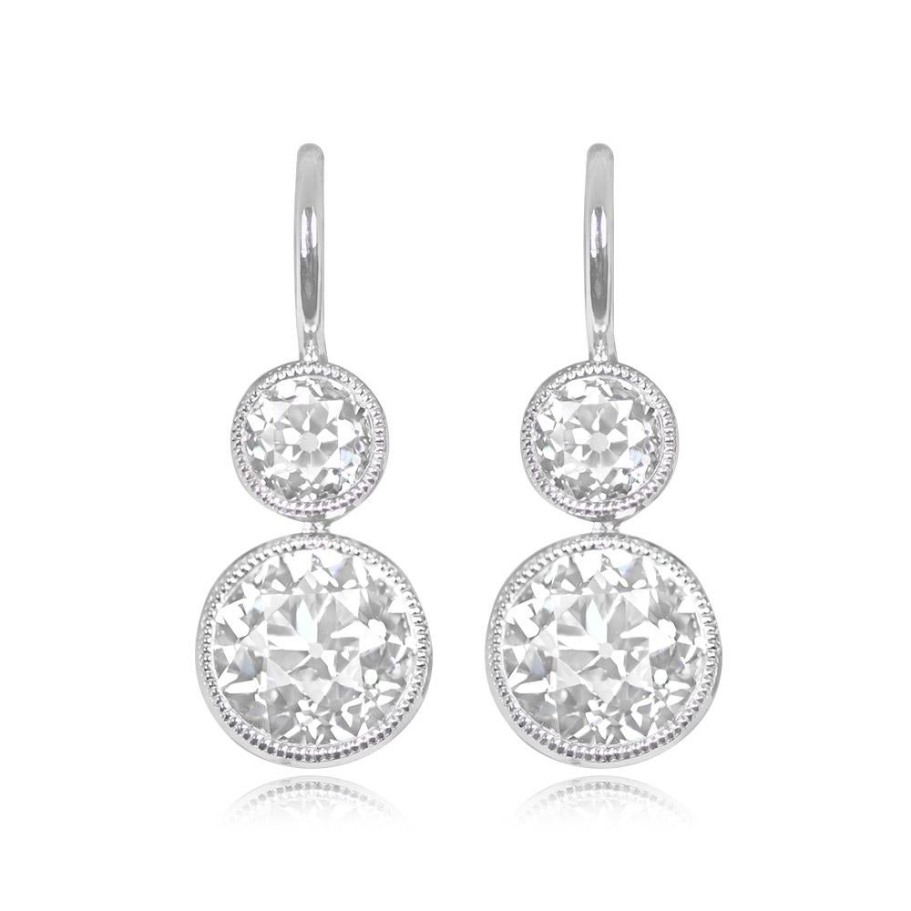 Discover understated elegance with these diamond earrings, showcasing bezel-set old European cut diamonds. The lower diamonds, weighing 1.88 carats combined, exhibit K color and VS2 clarity. Above, smaller diamonds weighing 0.63 carats combined add