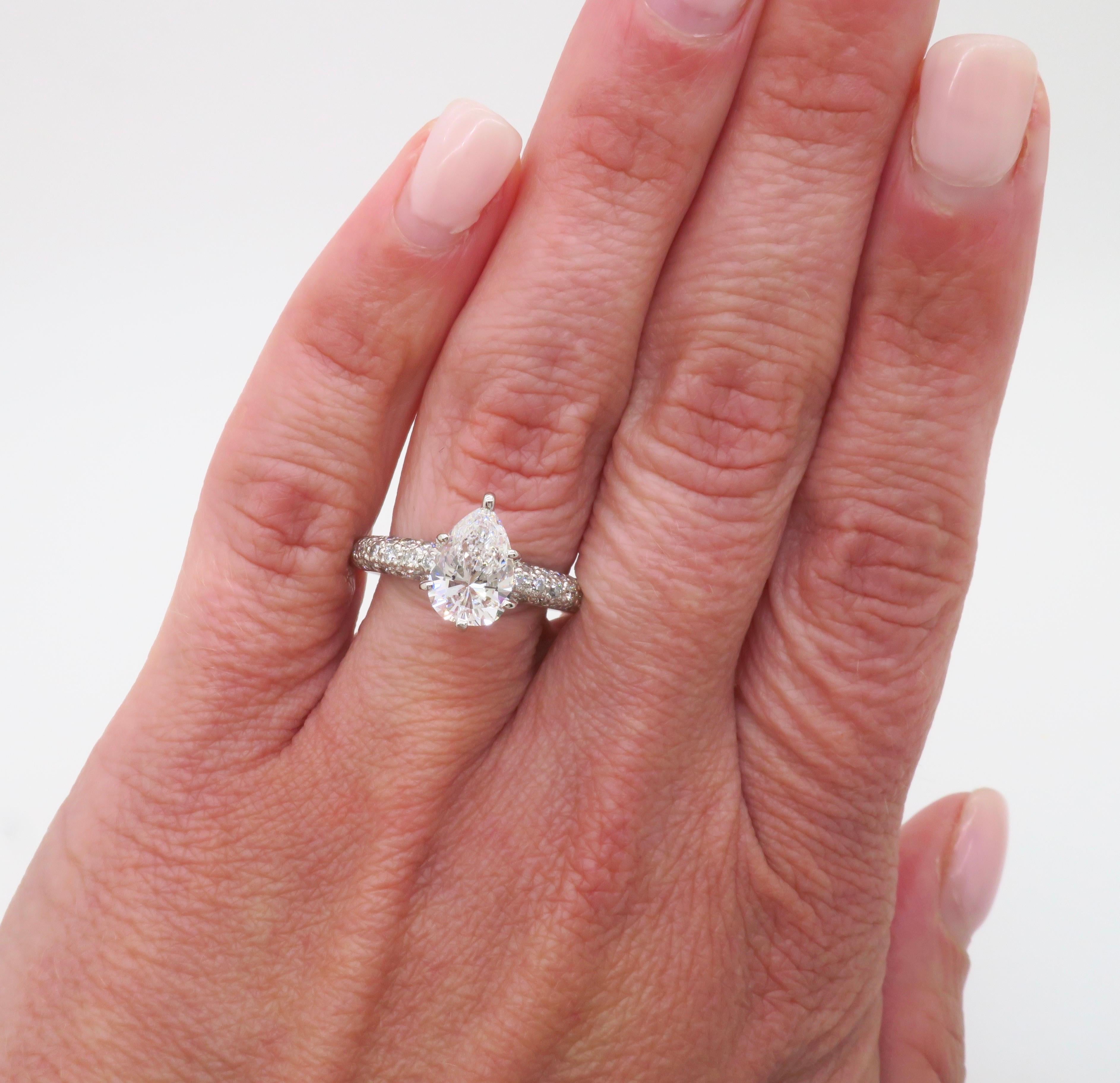 Stunning 1.88CTW Earth Mined diamond ring crafted in Platinum, featuring a Pear Brilliant cut diamond in the center.  

Center Diamond Carat Weight: 1.52CT 
Center Diamond Cut: Pear
Center Diamond Color: E
Center Diamond Clarity: SI1
Accent