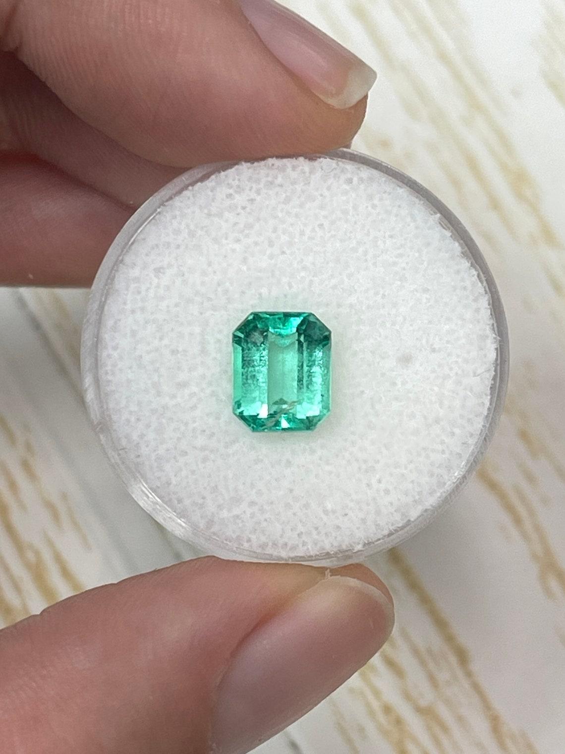 Stone: Emerald
Weight: 1.89-carats
Shape: Emerald Cut
Clarity: Transparent
Luster: Very Good
Color: Medium Yellowish Green
Measurements: 8.26mm x 6.78mm x 4.83mm
Geographic Origin: Colombia
Treatment: Natural, Oiling

Comments: Due to their growth
