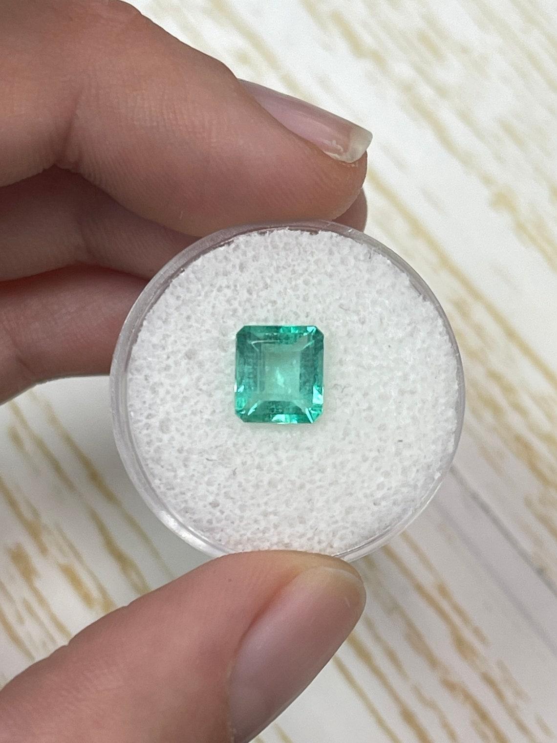 Stone: Emerald
Weight: 1.89-carats
Shape: Emerald Cut
Clarity: Transparent
Luster: Very Good-Good
Color: Pastel Green
Measurements: 8.10mm x 7.28mm x 4.54mm
Geographic Origin: Colombia
Treatment: Natural, Oiling

Comments: Due to their growth